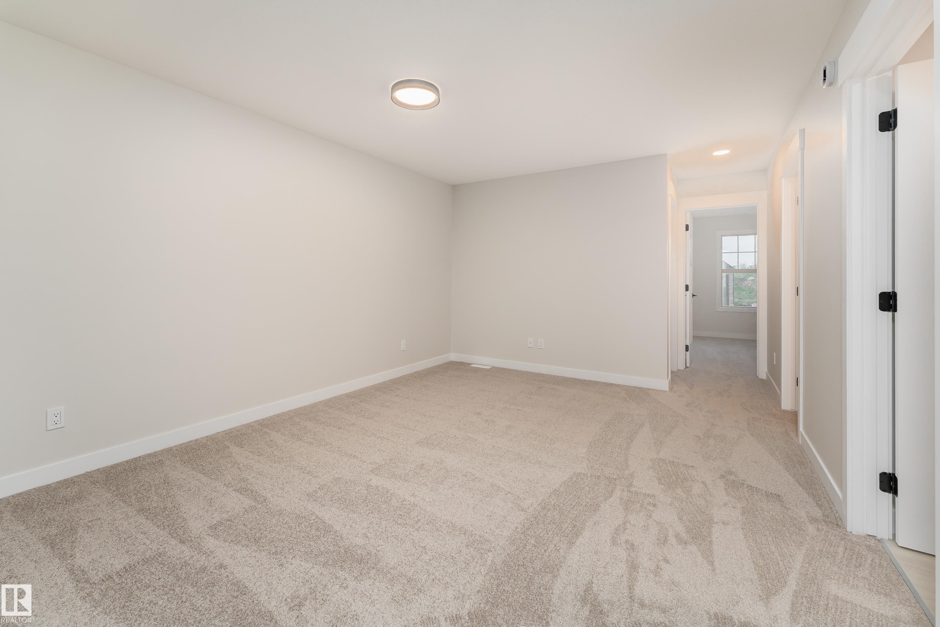 Neutral-toned wall paint and carpeting create a versatile interior - 115 Garneau Gate, Spruce Grove, AB