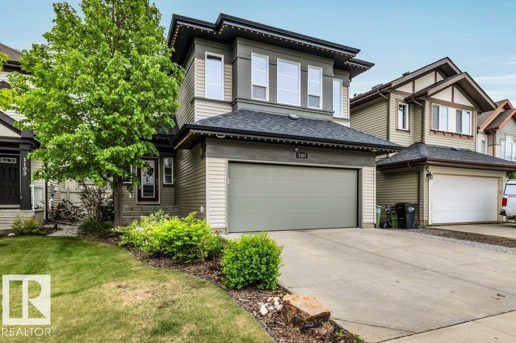 Contemporary two-story residence featuring a neutral-toned exterior with horizontal siding and accent panels - 1107 Chahley Crest, Edmonton, AB