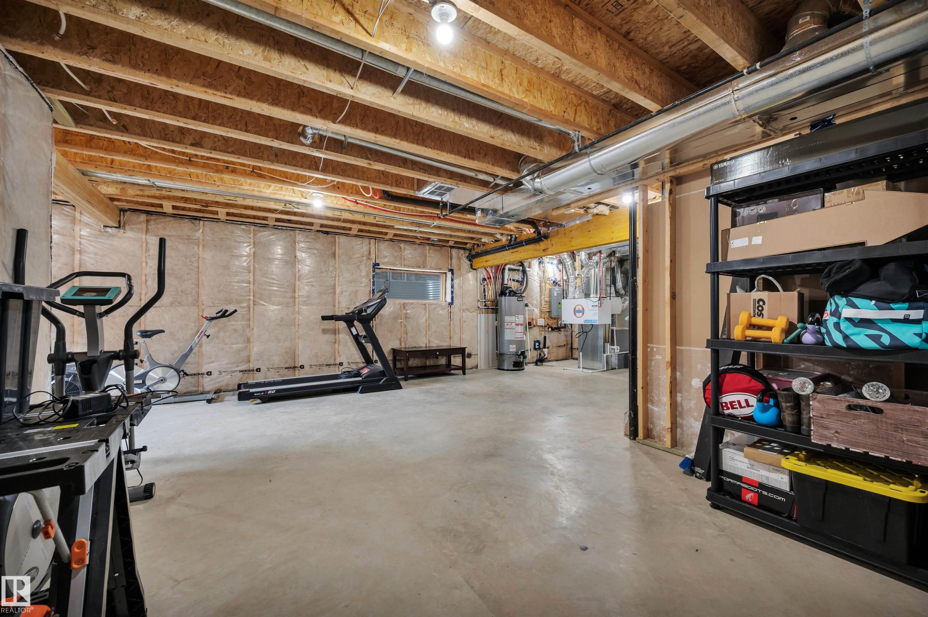 Unfinished basement featuring exposed wood joists, concrete flooring, and insulated perimeter walls - 3898 Robins Crescent Nw, Edmonton, AB - Indoor Photo Showing Basement