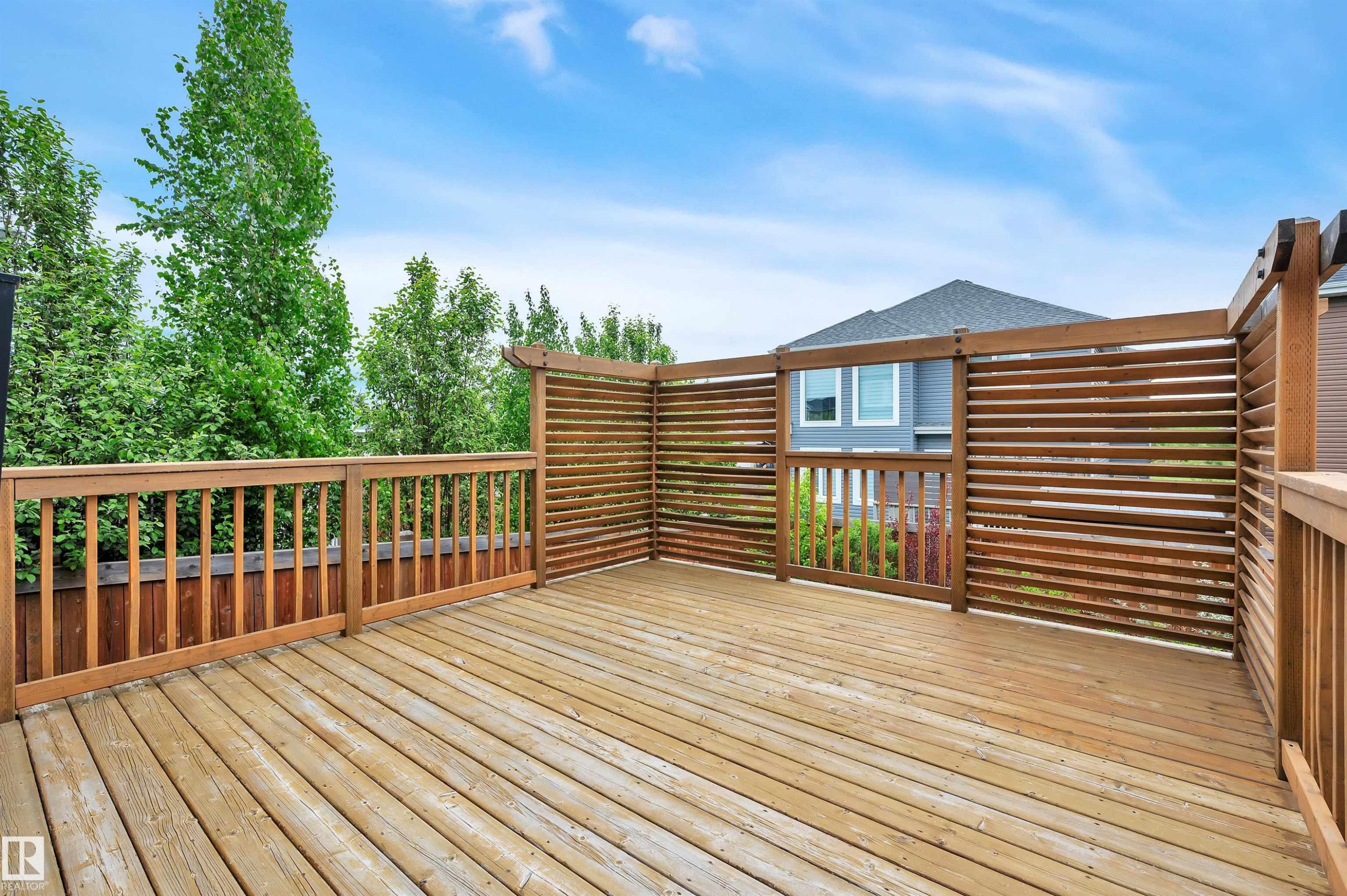Spacious wood-finish deck featuring slatted privacy screens and coordinating wood railings - 3898 Robins Crescent Nw, Edmonton, AB - Outdoor With Deck Patio Veranda With Exterior