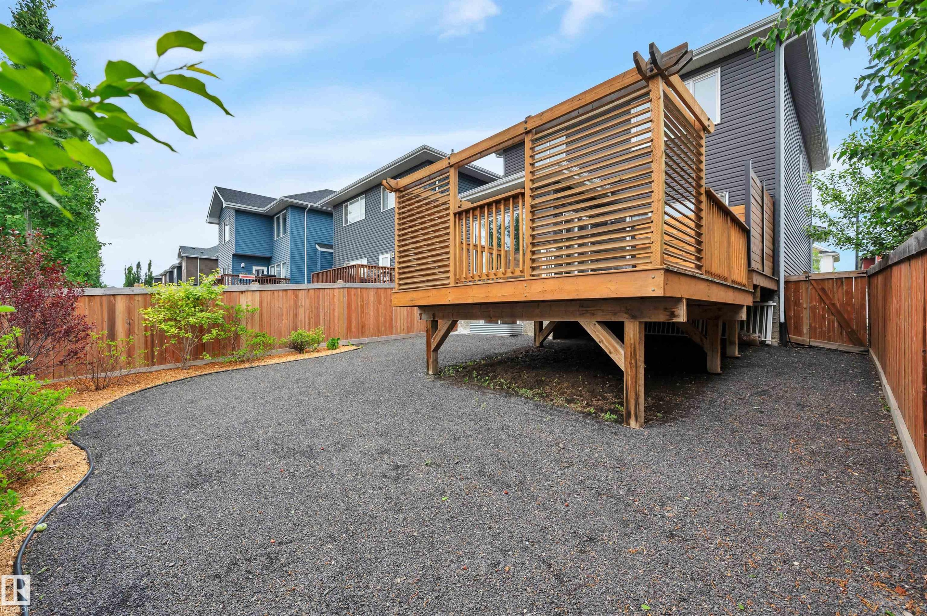 Raised wood deck featuring a slatted privacy screen and wood railing - 3898 Robins Crescent Nw, Edmonton, AB - Outdoor With Deck Patio Veranda