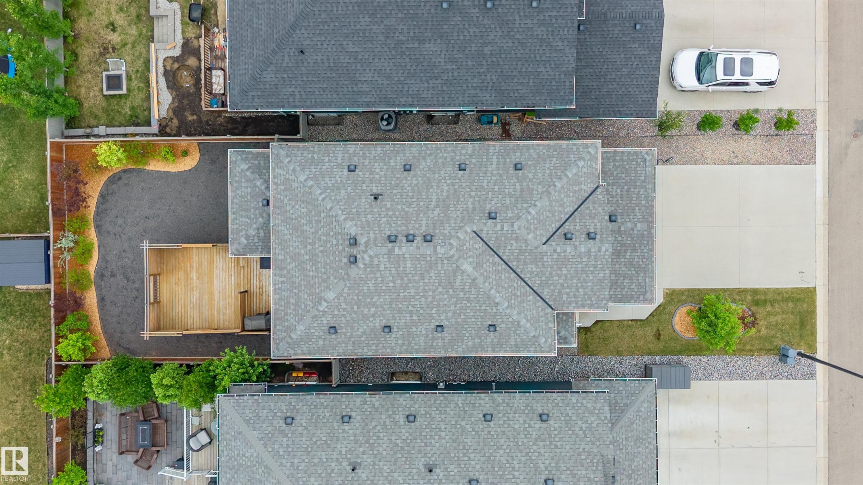 Overhead property perspective featuring a light gray shingle roof, a generously sized concrete driveway, and a wooden deck - 3898 Robins Crescent Nw, Edmonton, AB - Outdoor