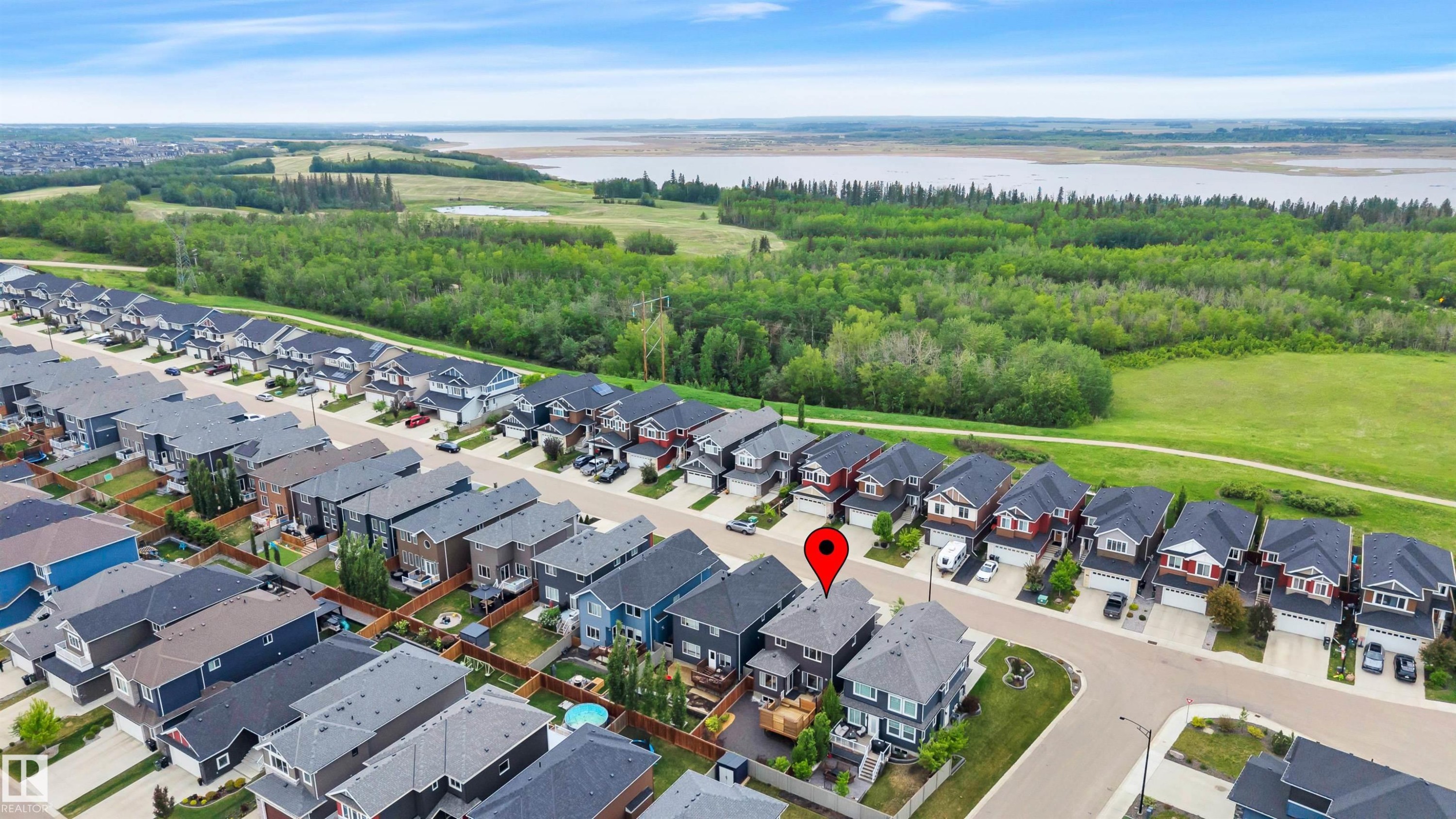 Aerial perspective showcasing a residential neighborhood with modern detached homes - 3898 Robins Crescent Nw, Edmonton, AB - Outdoor With Body Of Water With View