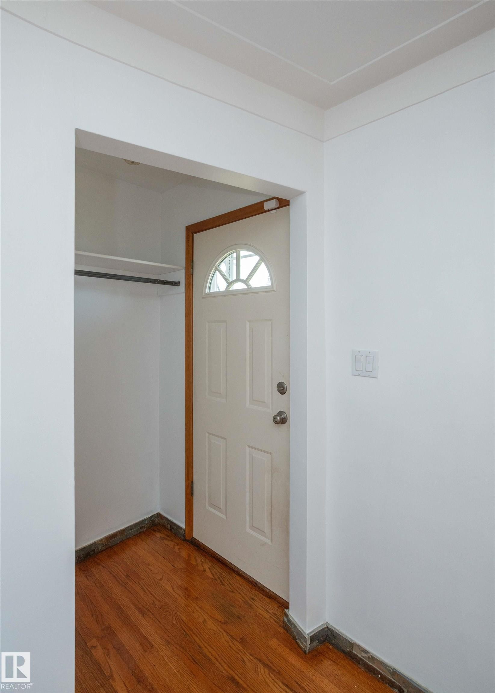 Entryway featuring a paneled door with an arched transom window - 4414 54 Avenue, Barrhead, AB - Indoor Photo Showing Other Room