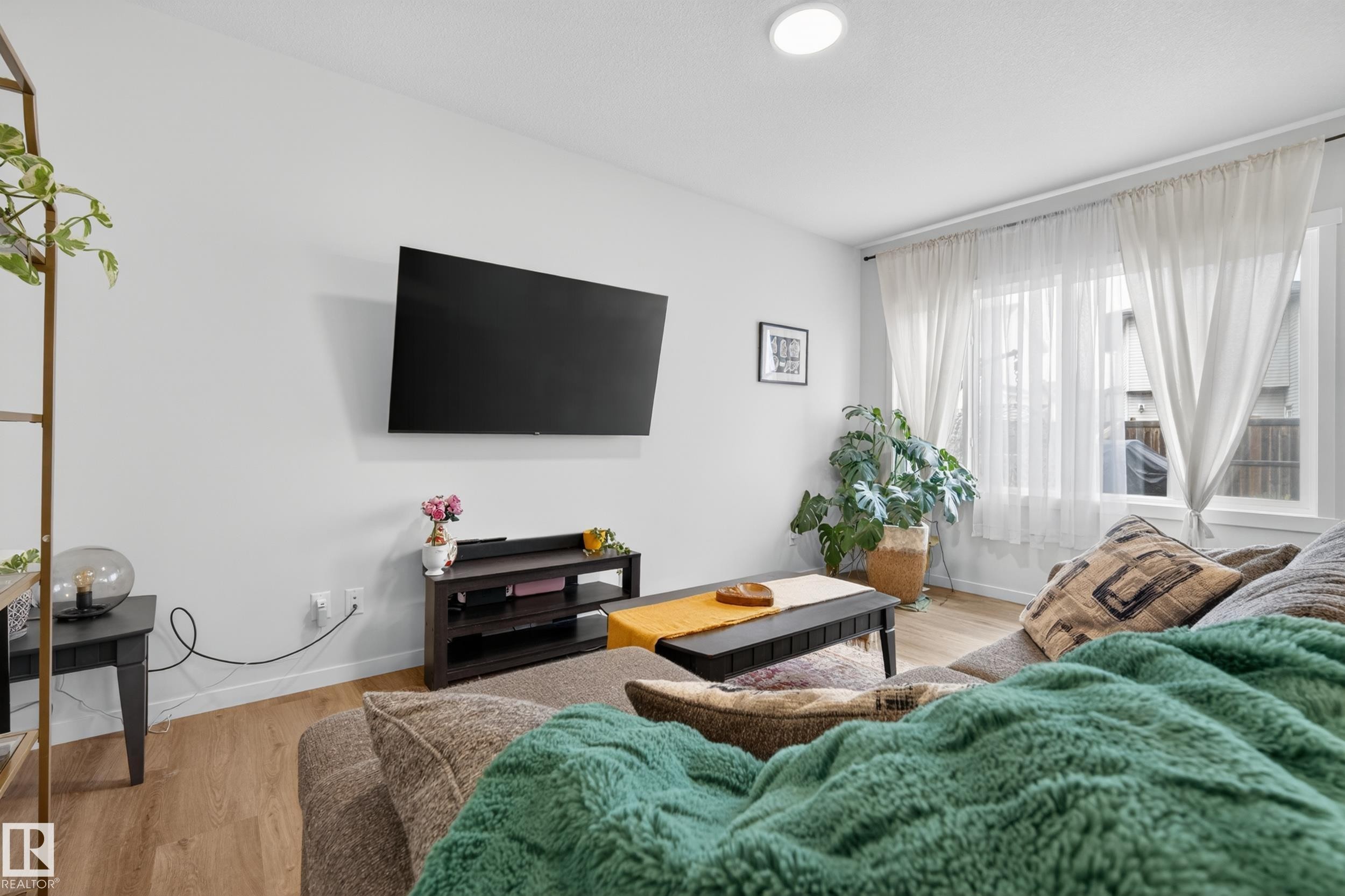 Living area featuring light wood-finish flooring, white walls, and recessed ceiling lighting - 22836 94 Avenue, Edmonton, AB