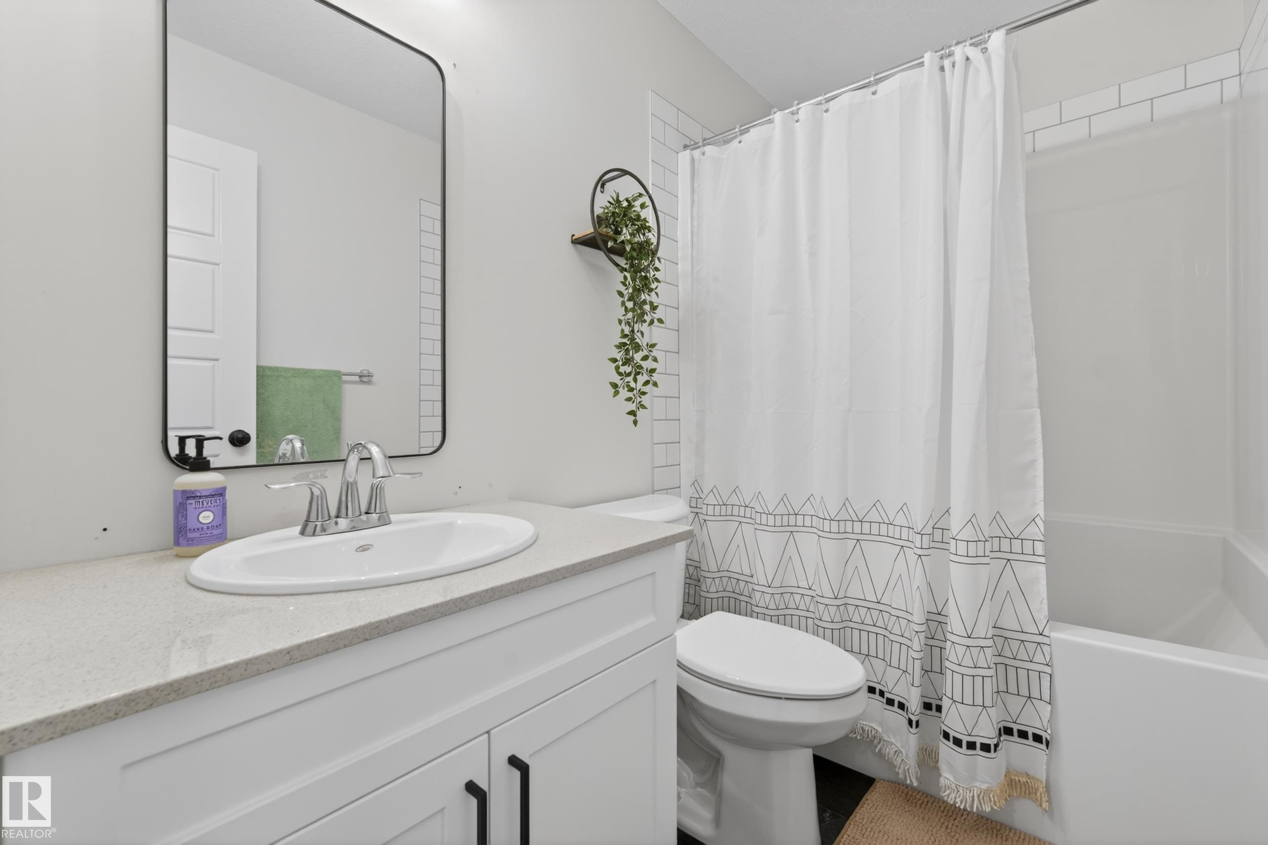 White vanity with a light-toned countertop and an undermount sink - 22836 94 Avenue, Edmonton, AB