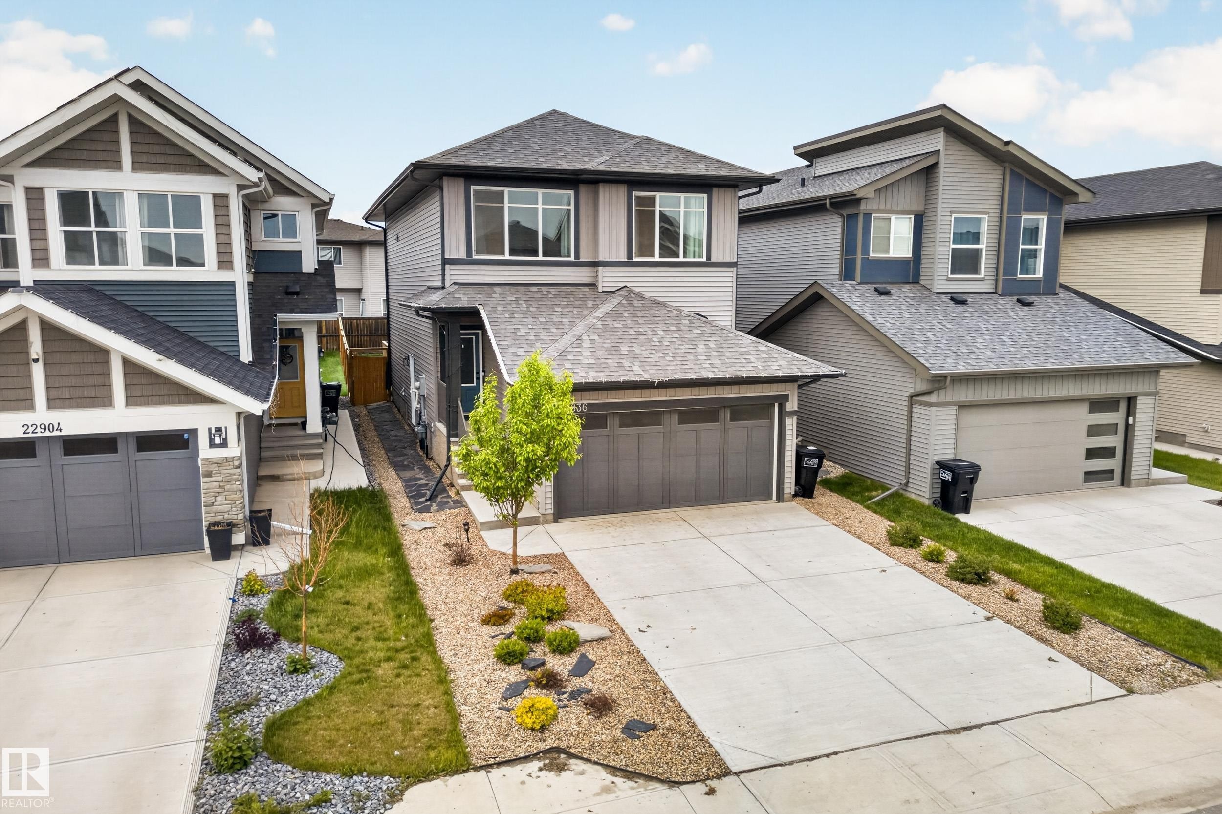 Contemporary two-story home featuring a grey exterior with varied siding textures - 22836 94 Avenue, Edmonton, AB