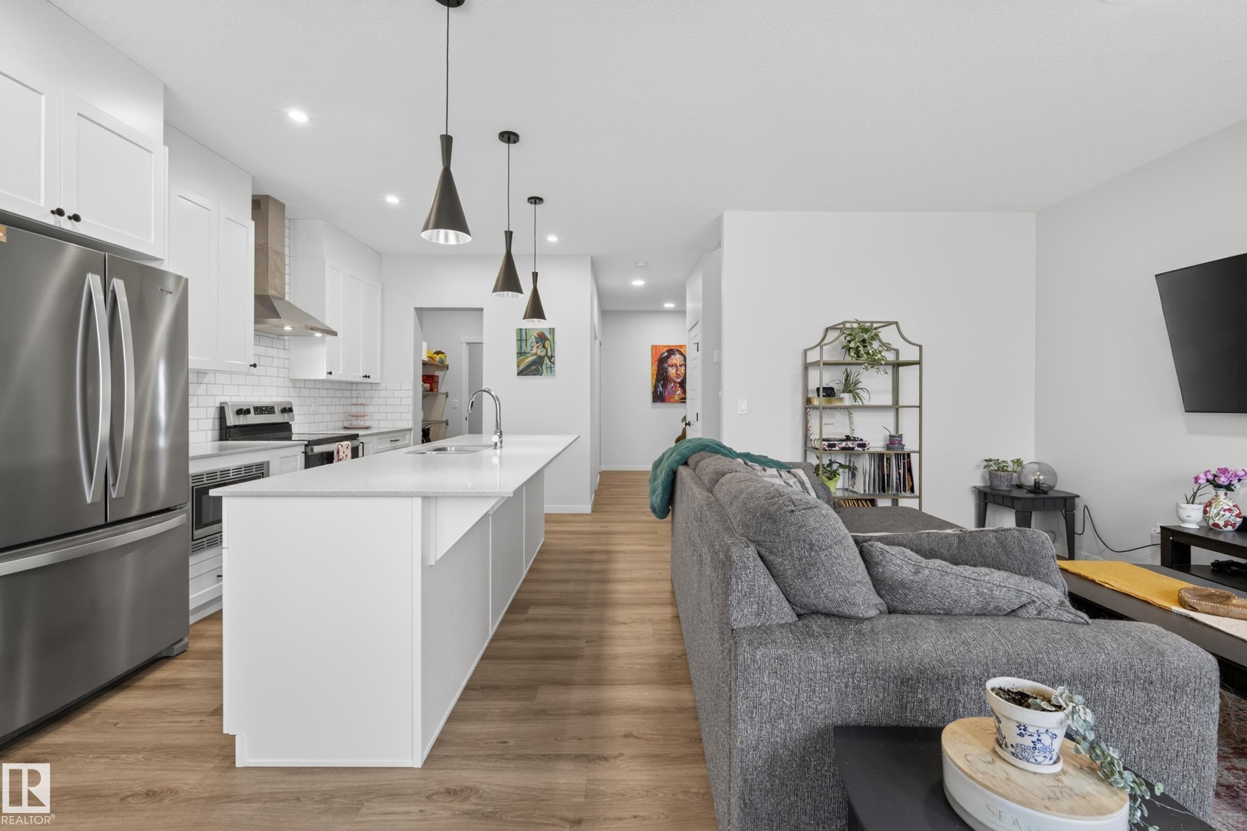 Open-concept kitchen and living area featuring wood-finish flooring - 22836 94 Avenue, Edmonton, AB