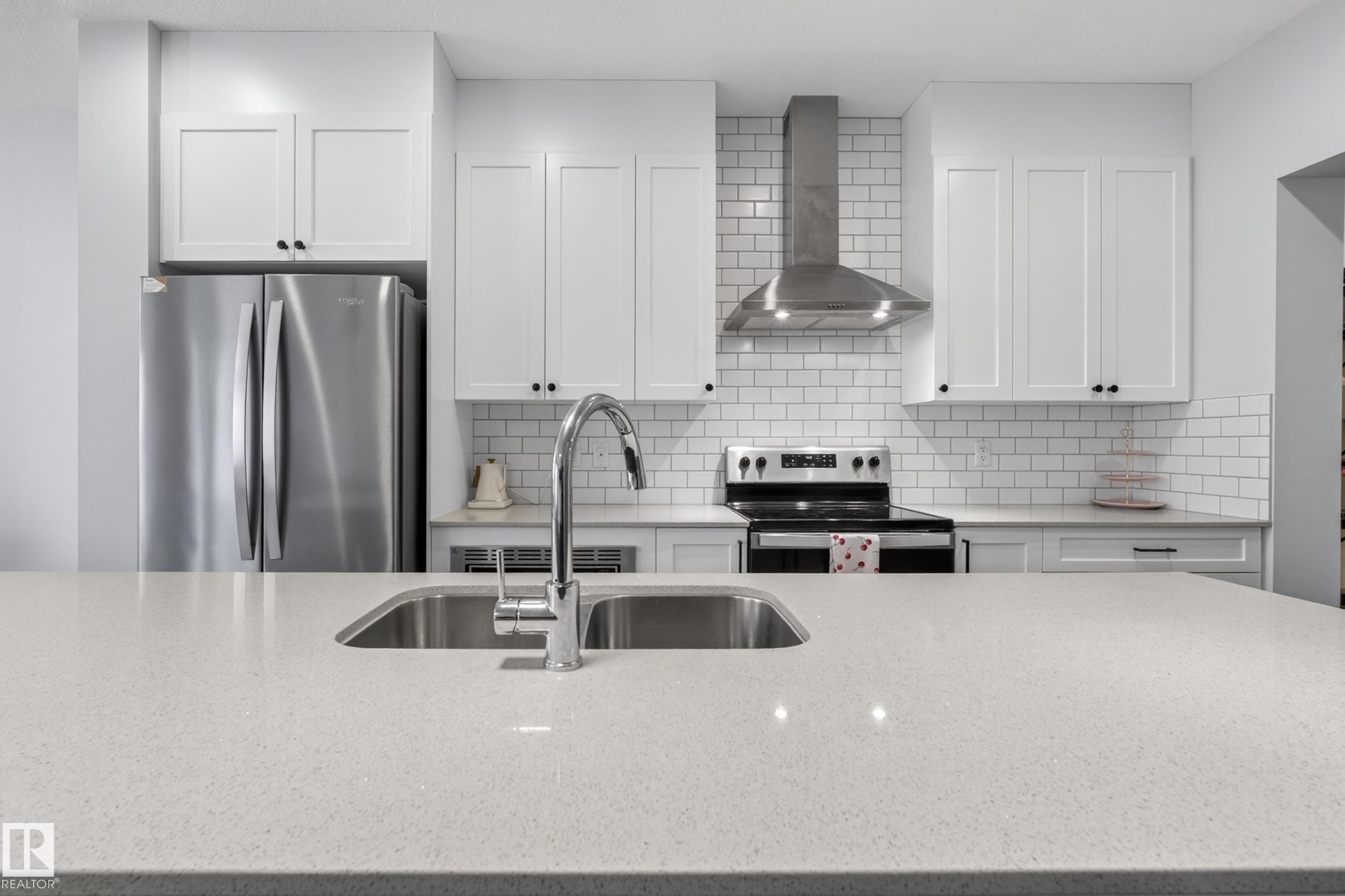 Expansive kitchen island with an undermount double basin sink and gooseneck faucet - 22836 94 Avenue, Edmonton, AB