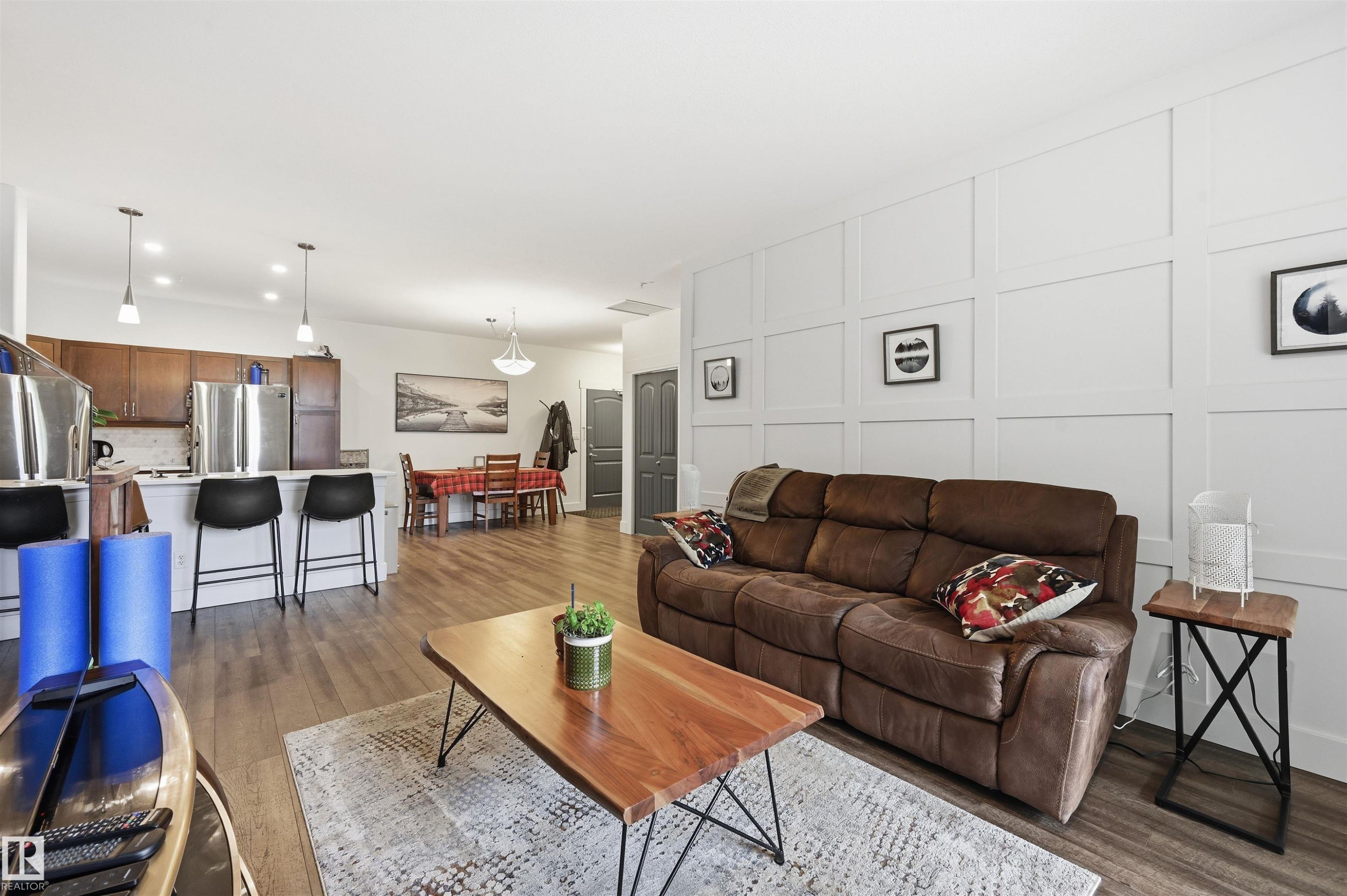 Open-concept living space with wood-finish flooring - 217 2503 Hanna Crescent, Edmonton, AB