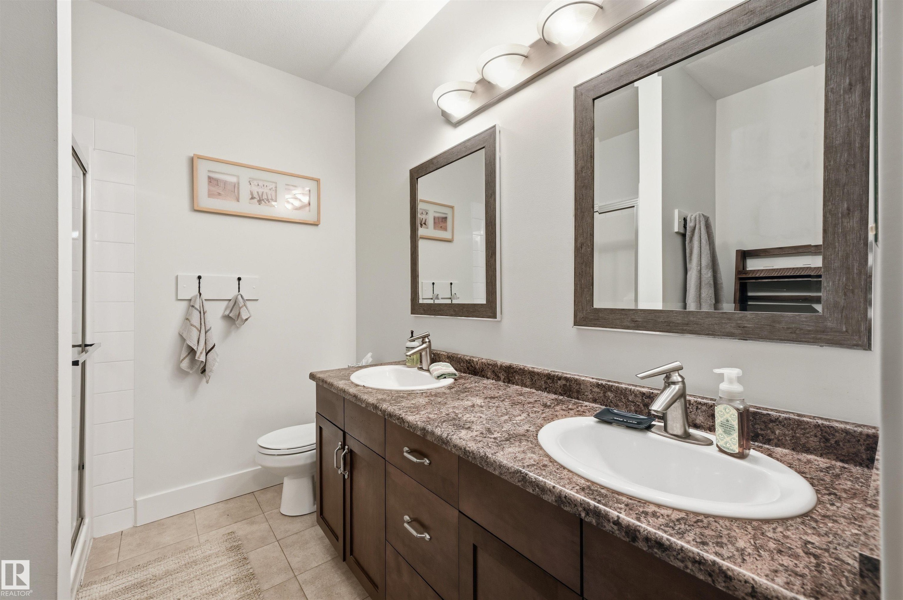 Dual vanity with undermount sinks and dark wood-finish cabinetry - 217 2503 Hanna Crescent, Edmonton, AB