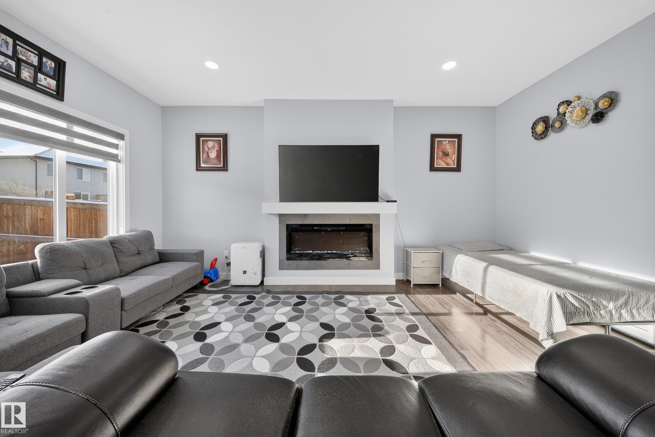 Living area featuring a modern fireplace with a white mantel and a dark hearth - 2084 Graydon Hill, Edmonton, AB