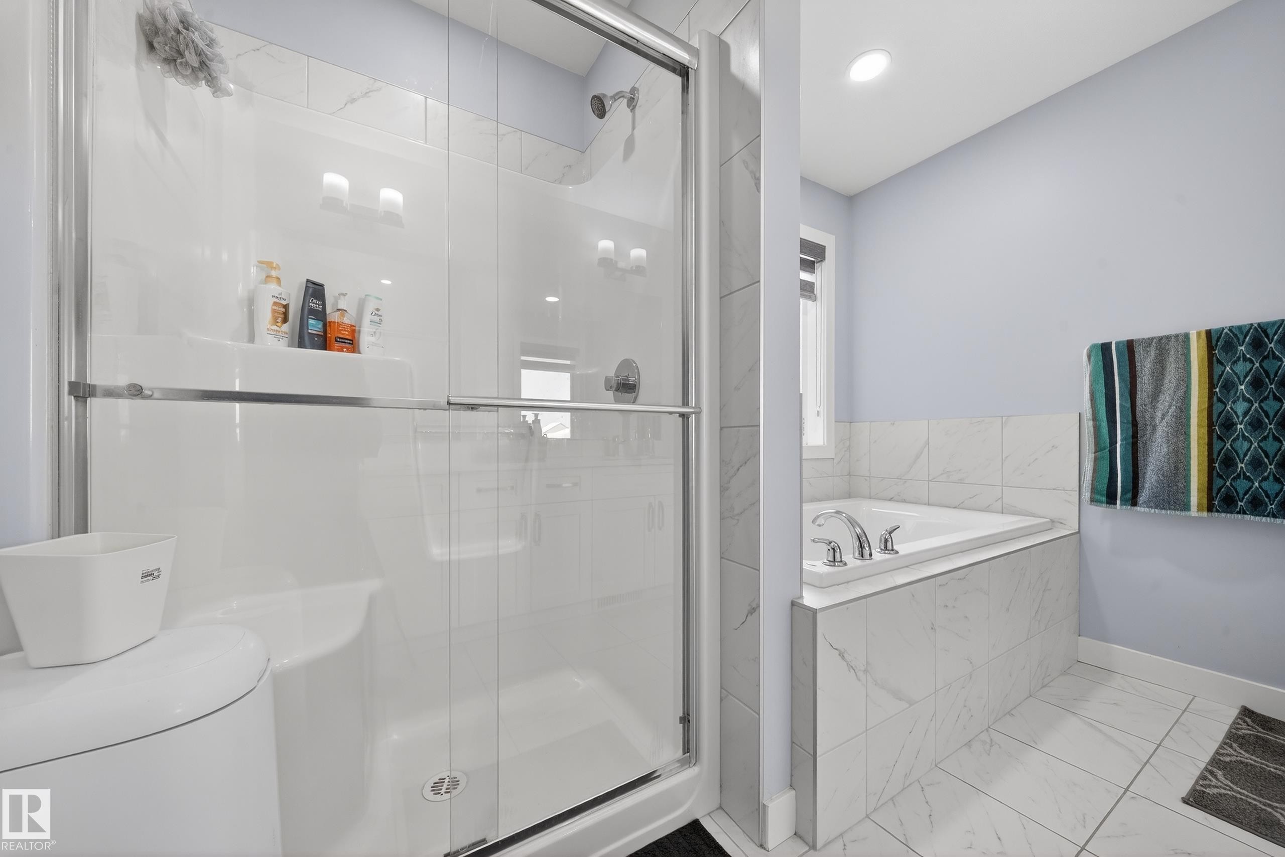 Shower enclosure with clear glass door, built-in shelf, and chrome fixtures - 2084 Graydon Hill, Edmonton, AB
