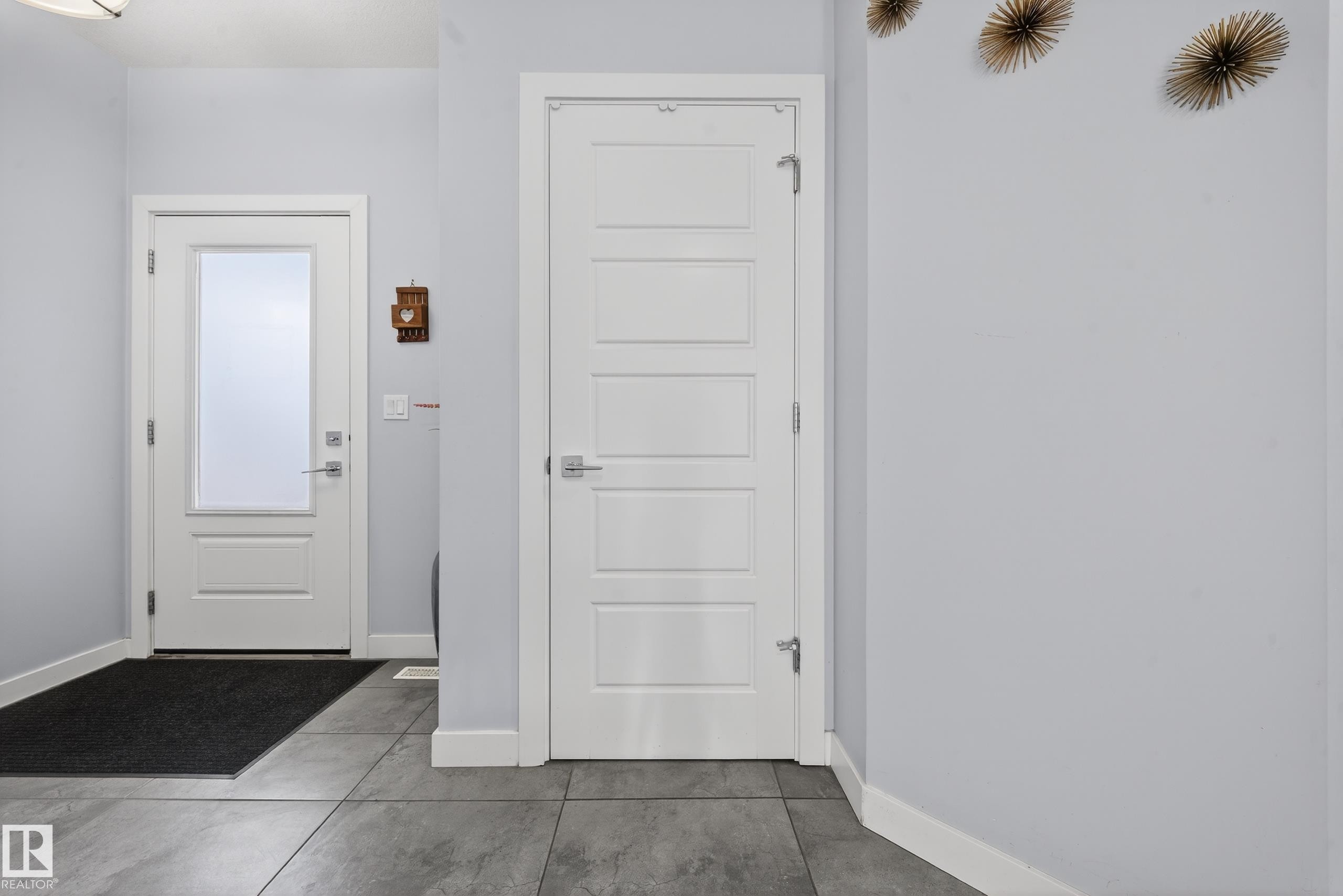 Entryway featuring large format tile flooring and a white paneled door with frosted glass - 2084 Graydon Hill, Edmonton, AB