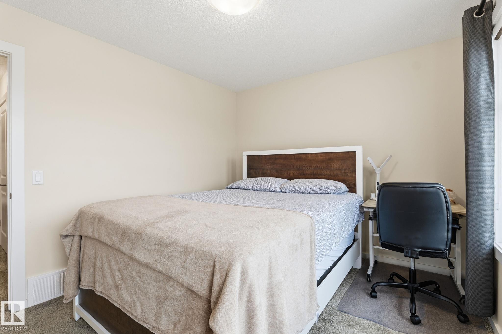 Carpeted room with a ceiling-mounted light fixture and light-toned wall paint - 20011 26, Edmonton, AB
