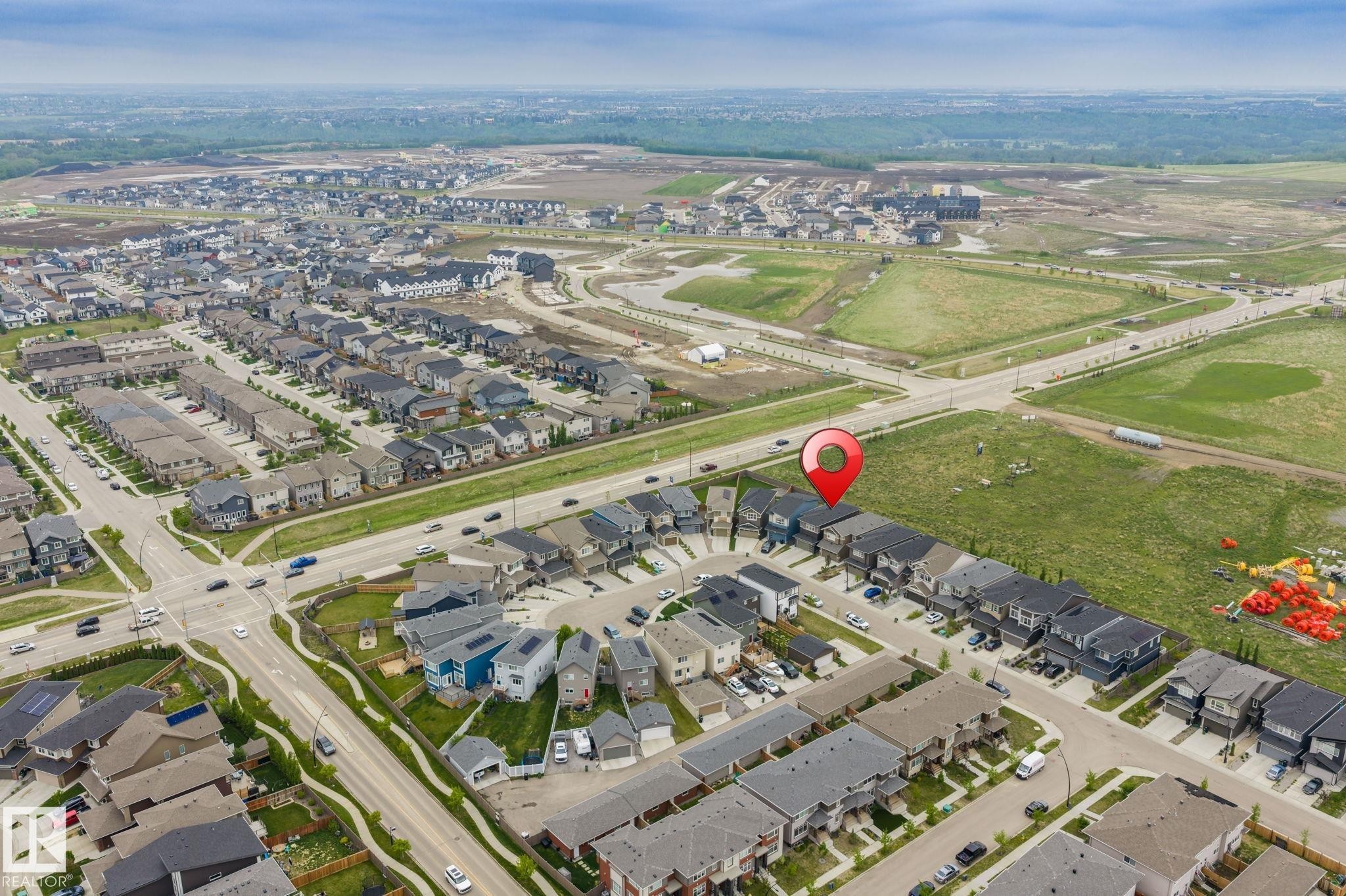 Aerial perspective of a developed residential community with ongoing expansion - 20011 26, Edmonton, AB