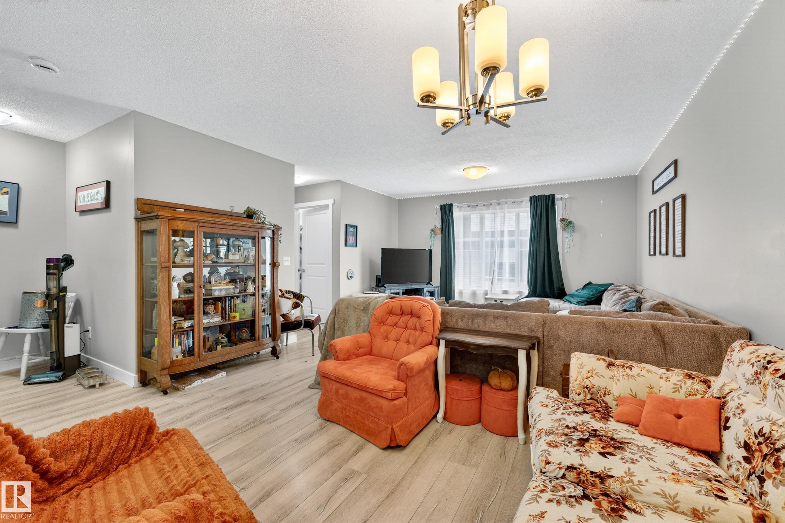 Open-concept living area featuring light wood-finish flooring throughout - 85 165 Cy Becker Boulevard, Edmonton, AB - Indoor Photo Showing Living Room
