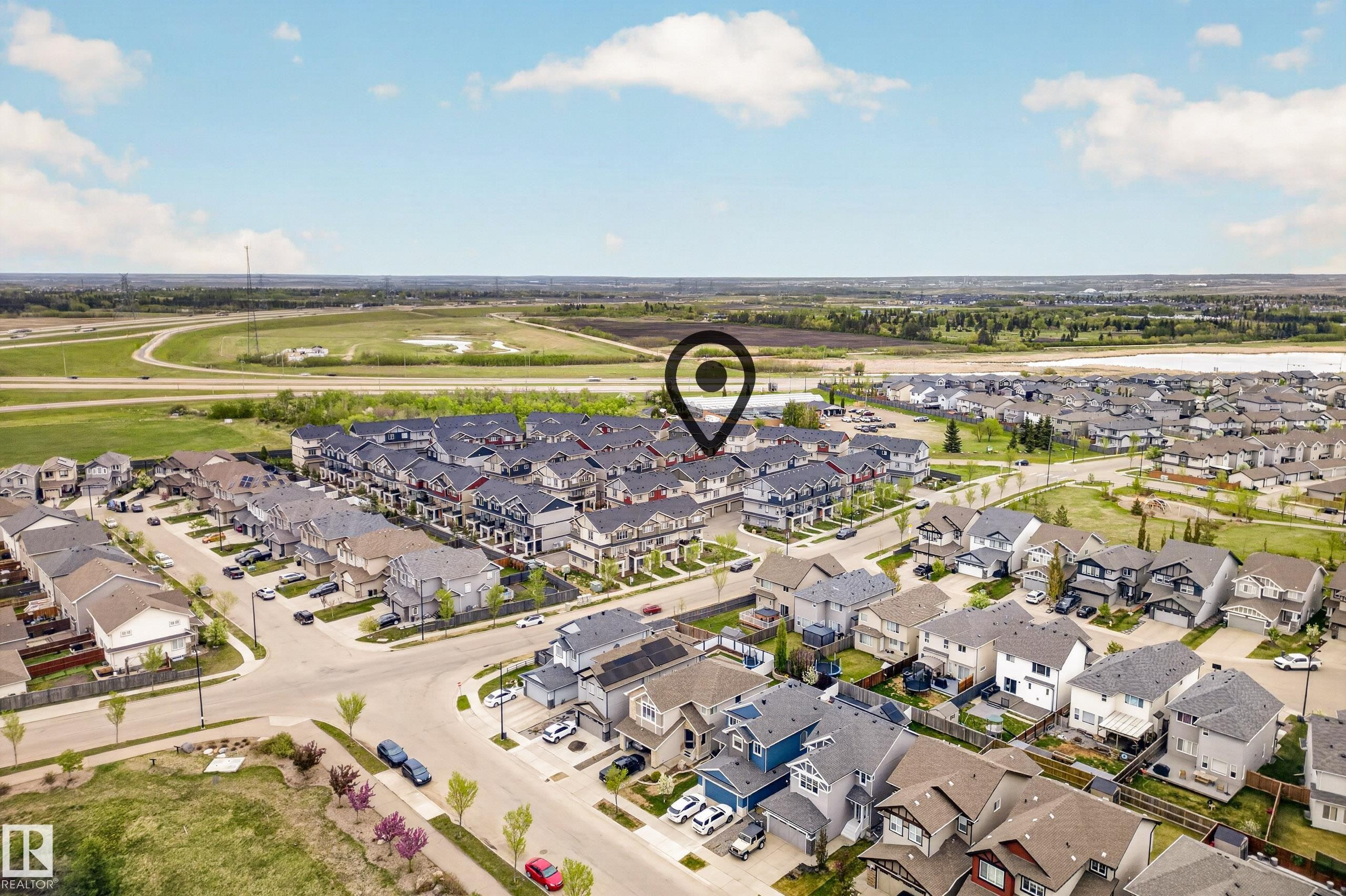 Aerial perspective of a residential neighborhood featuring a mix of detached homes and townhomes - 85 165 Cy Becker Boulevard, Edmonton, AB - Outdoor With View