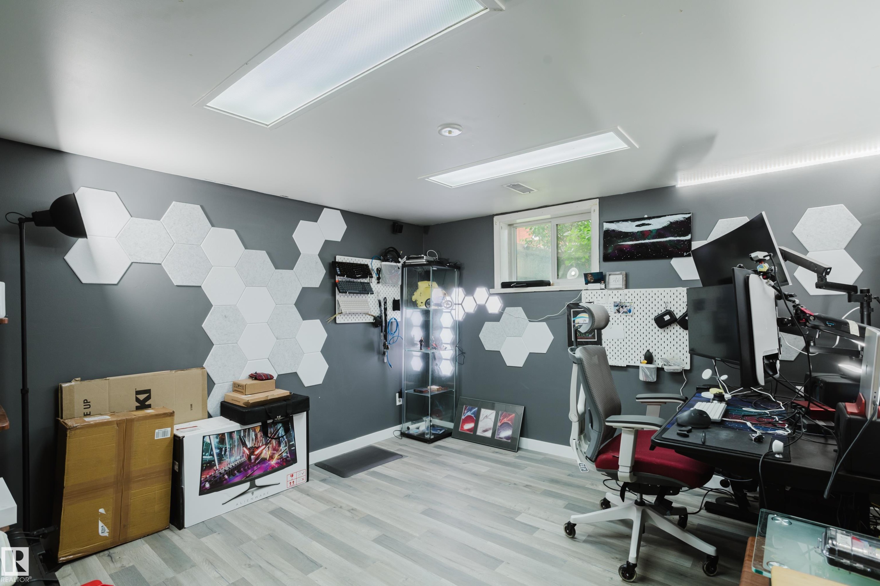 Room featuring light wood-finish flooring and dark gray walls - 11158 65 Street, Edmonton, AB