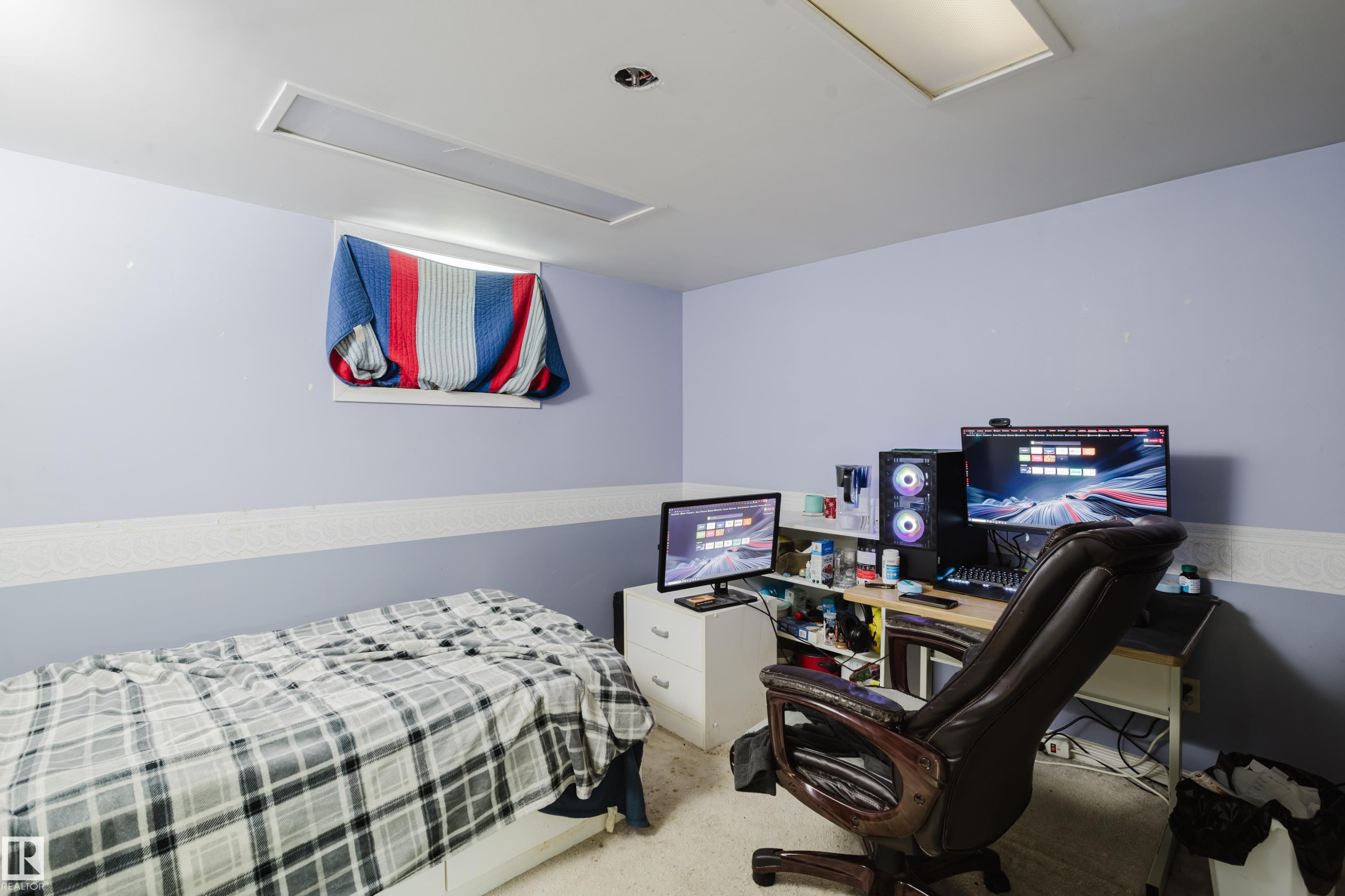 Room featuring light purple walls with a textured white accent strip, recessed lighting fixtures, and a window opening - 11158 65 Street, Edmonton, AB