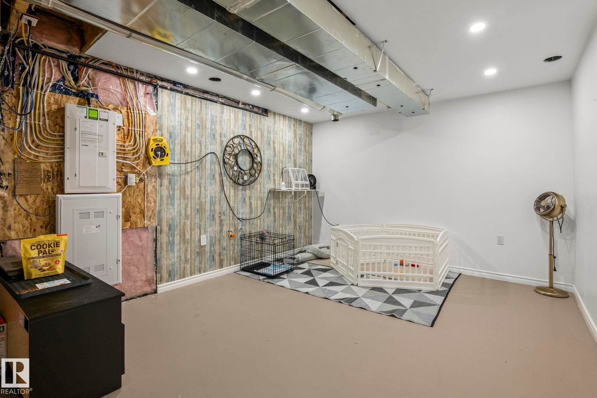 Partially finished basement featuring exposed utilities, a decorative wall, and recessed ceiling lighting - 20227 17Ave, Edmonton, AB