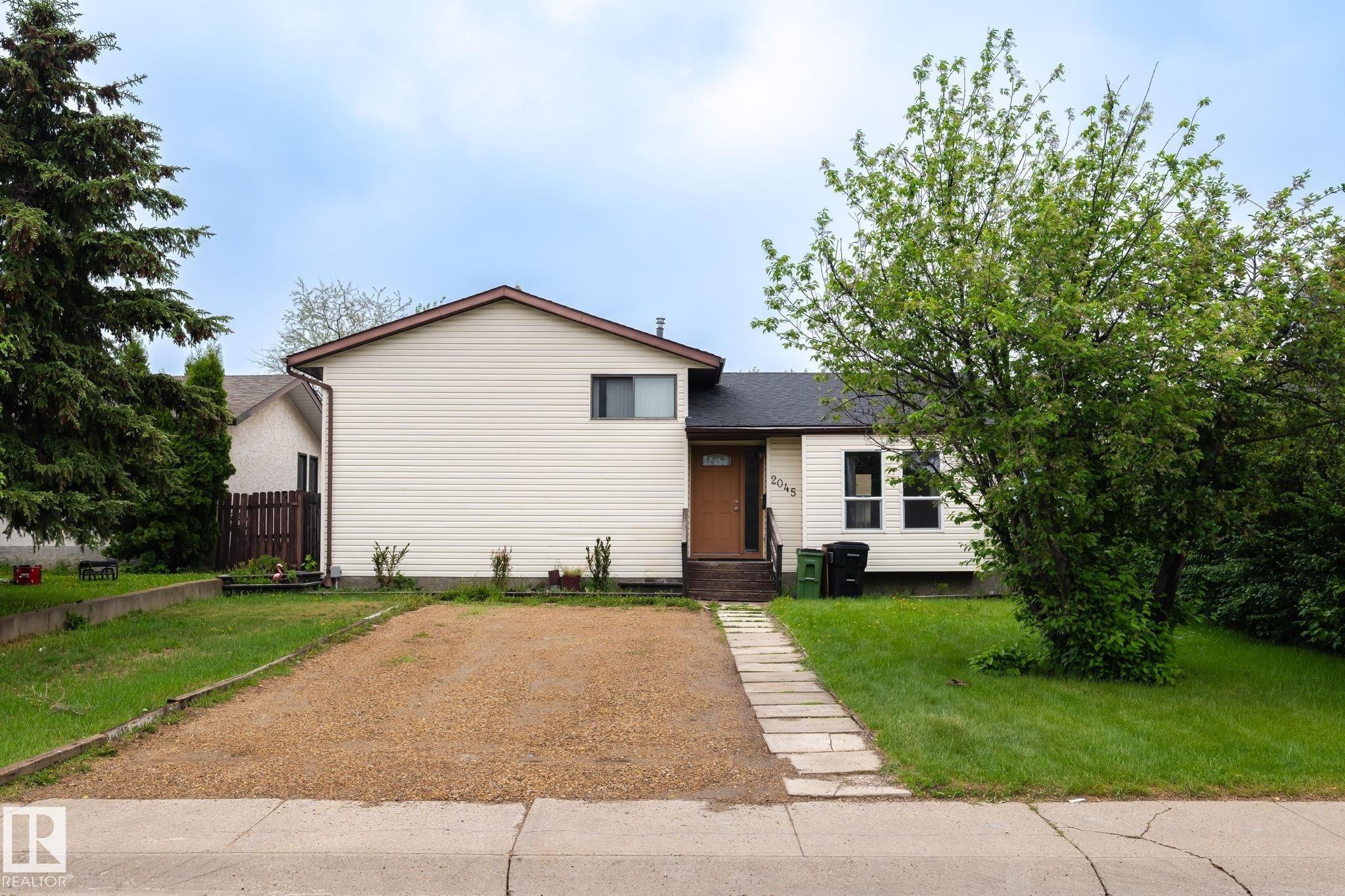 Cream-colored siding exterior with a brown trim roof - 2045 46St, Edmonton, AB