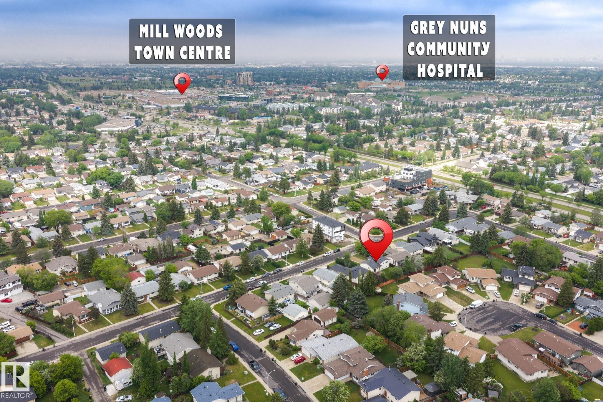 Aerial perspective of a residential neighborhood featuring numerous single-family homes with pitched roofs and mature tree-lined streets - 2045 46St, Edmonton, AB
