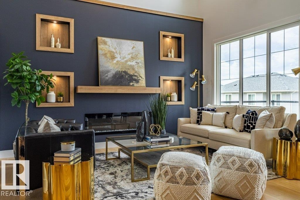 Living area featuring a dark accent wall with integrated wood-finish display niches, a linear electric fireplace, and a wood-finish mantel - 82 Wynn Rd, Fort Saskatchewan, AB