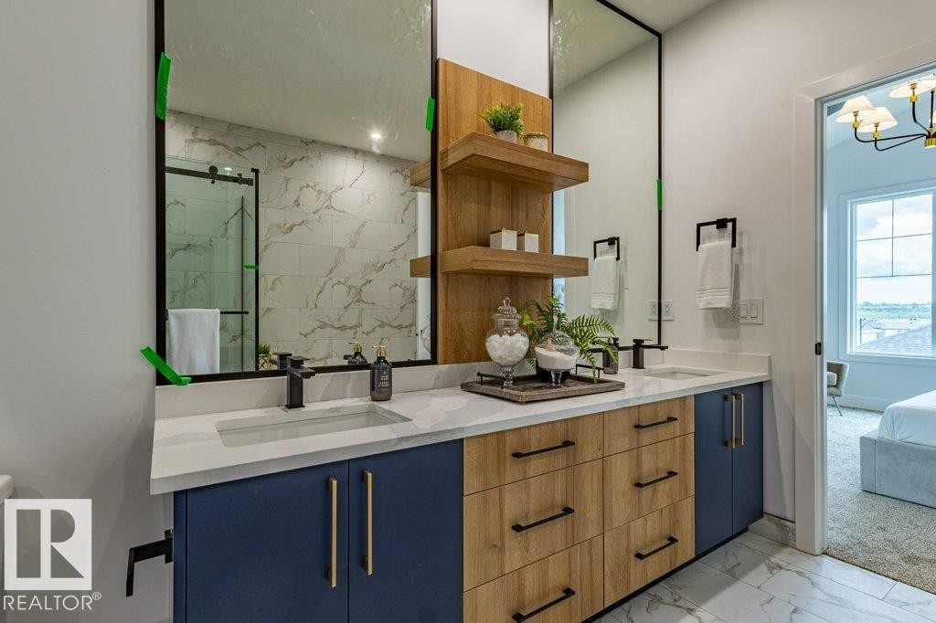 Dual vanity with a stone countertop, featuring undermount sinks and matte black fixtures - 82 Wynn Rd, Fort Saskatchewan, AB