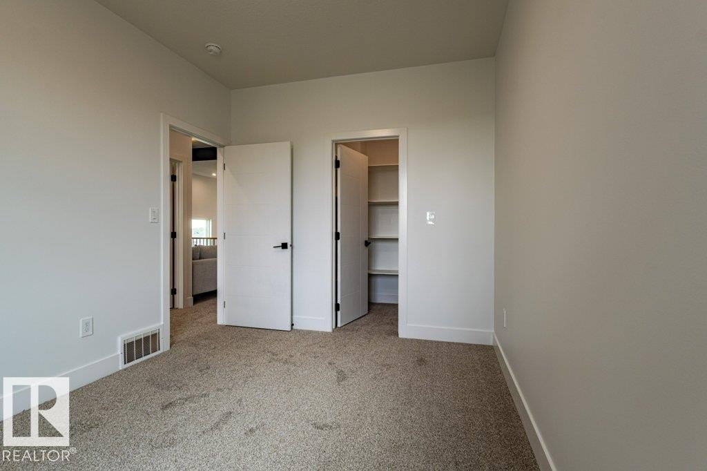 Neutral-toned carpeting throughout - 82 Wynn Rd, Fort Saskatchewan, AB