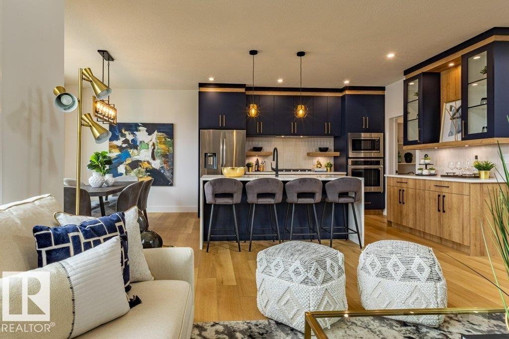 Open-concept kitchen and dining area featuring hardwood flooring - 82 Wynn Rd, Fort Saskatchewan, AB