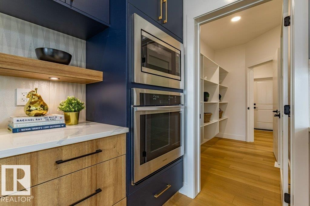 Kitchen pantry featuring extensive white shelving - 82 Wynn Rd, Fort Saskatchewan, AB
