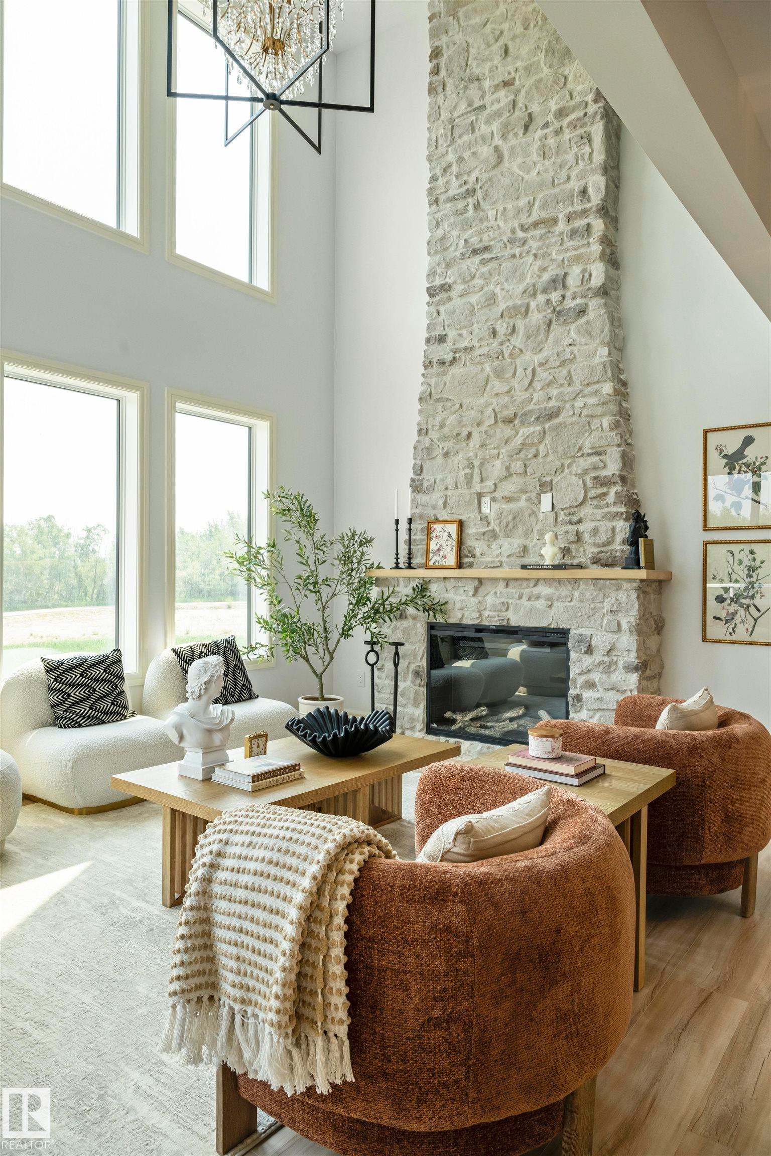 Two-story living area featuring a full-height stone fireplace with a wood mantel - 3329 Chickadee Drive, Edmonton, AB