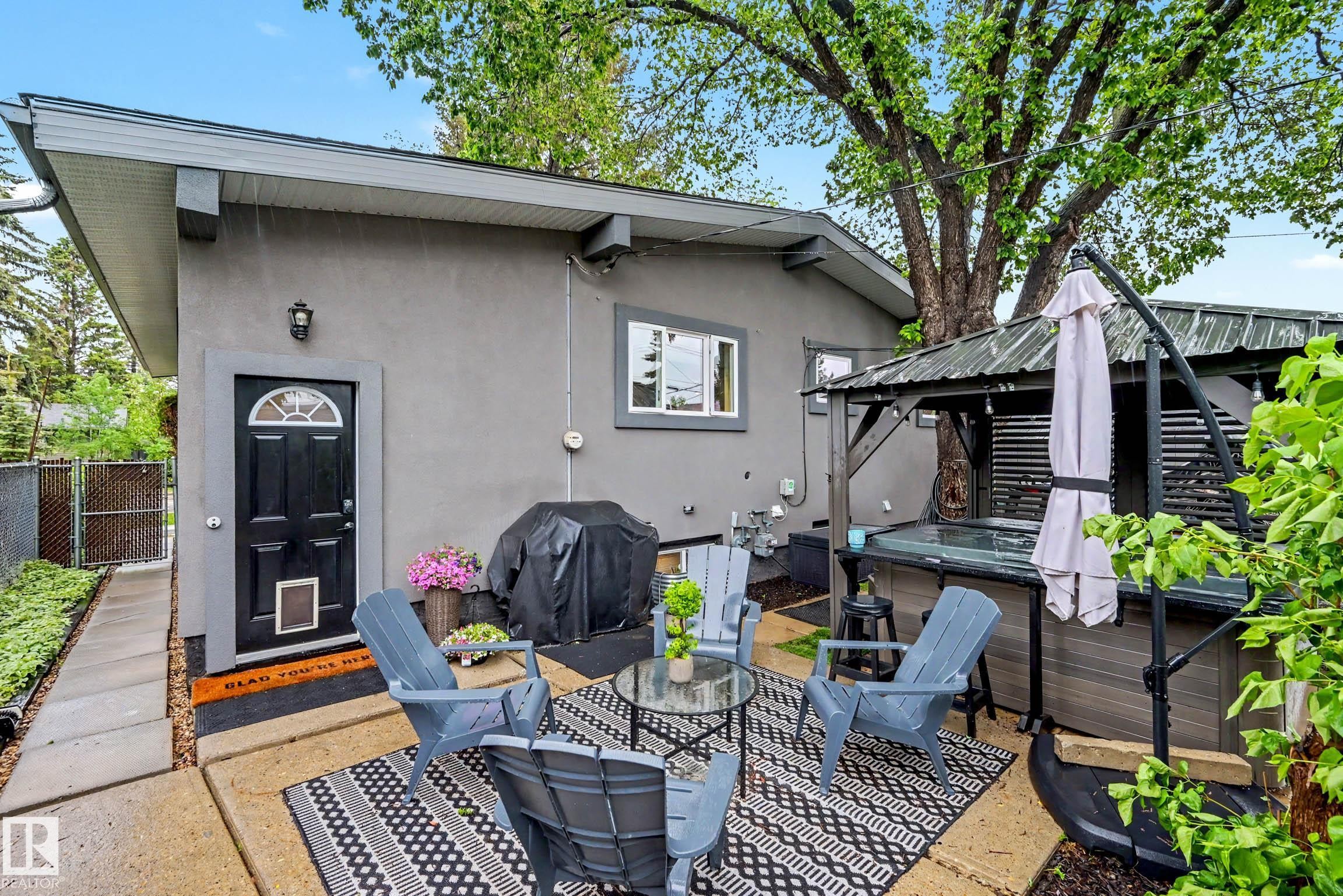 Exterior patio with a private hot tub under a gazebo - 12115 40 Avenue Nw, Edmonton, AB