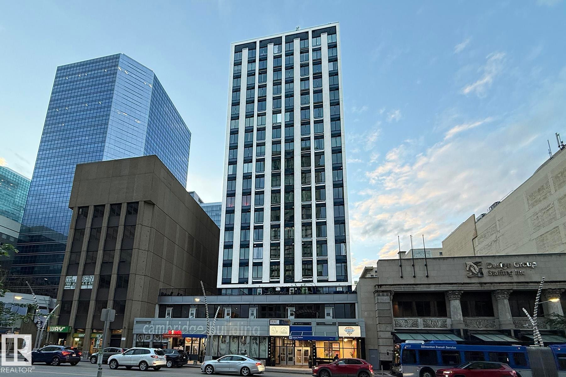 Modern high-rise building featuring a white and dark facade with numerous windows - #412 10024 Jasper Av Nw, Edmonton, AB - Outdoor With Facade