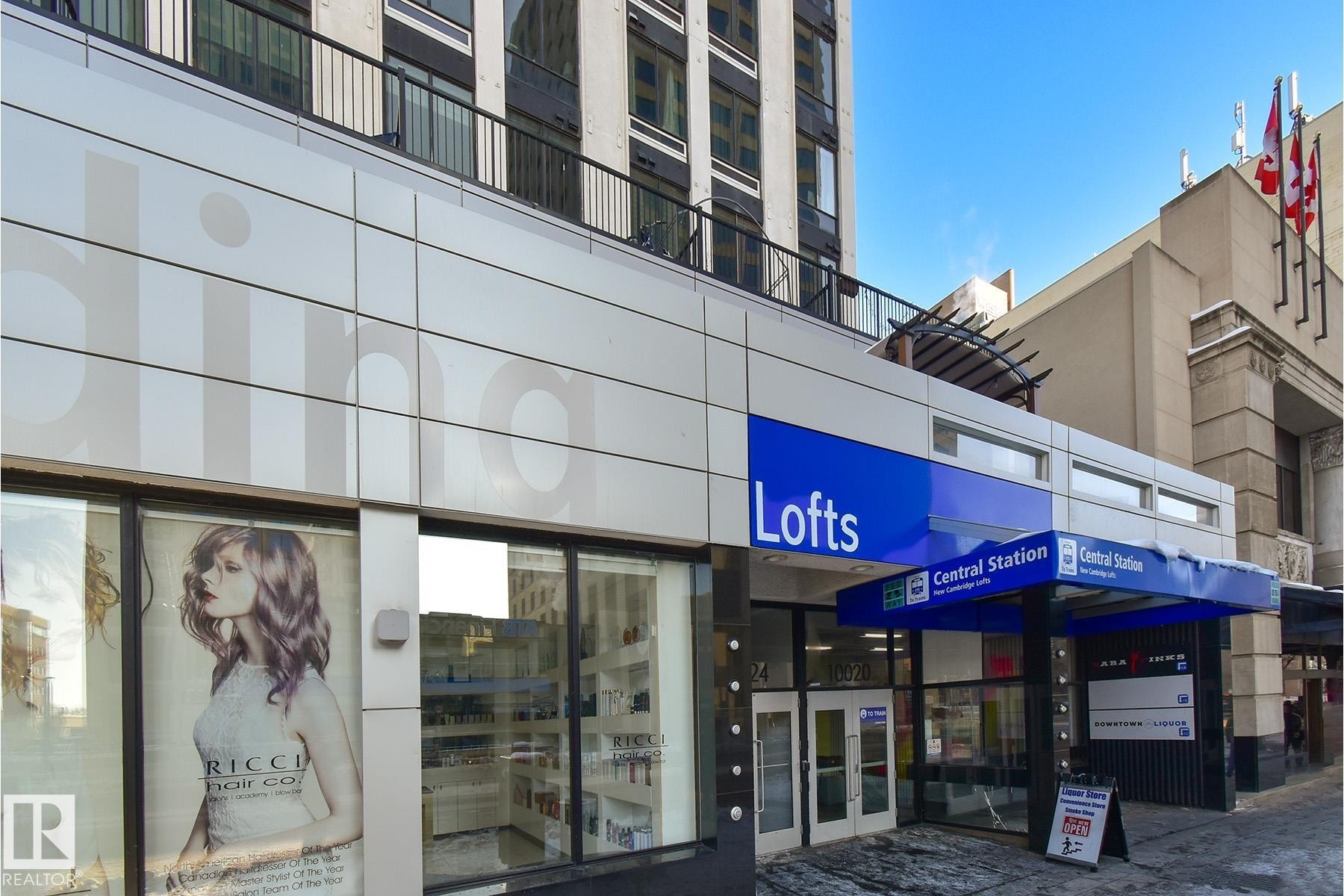 Modern building facade featuring ground-floor retail and upper-level residential units - #412 10024 Jasper Av Nw, Edmonton, AB - Outdoor