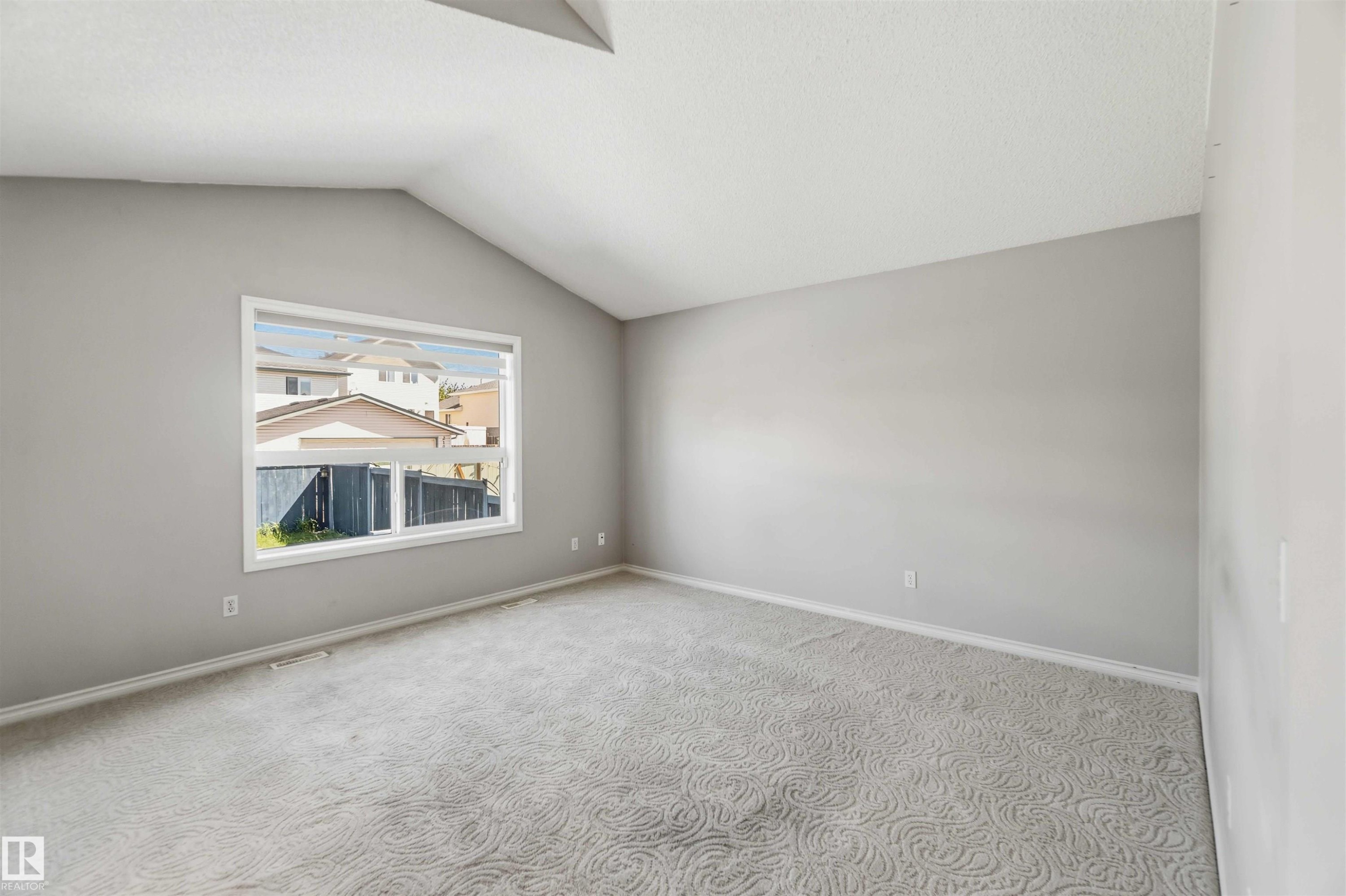 Spacious room featuring vaulted ceilings and a large window - 2012 35A Avenue, Edmonton, AB