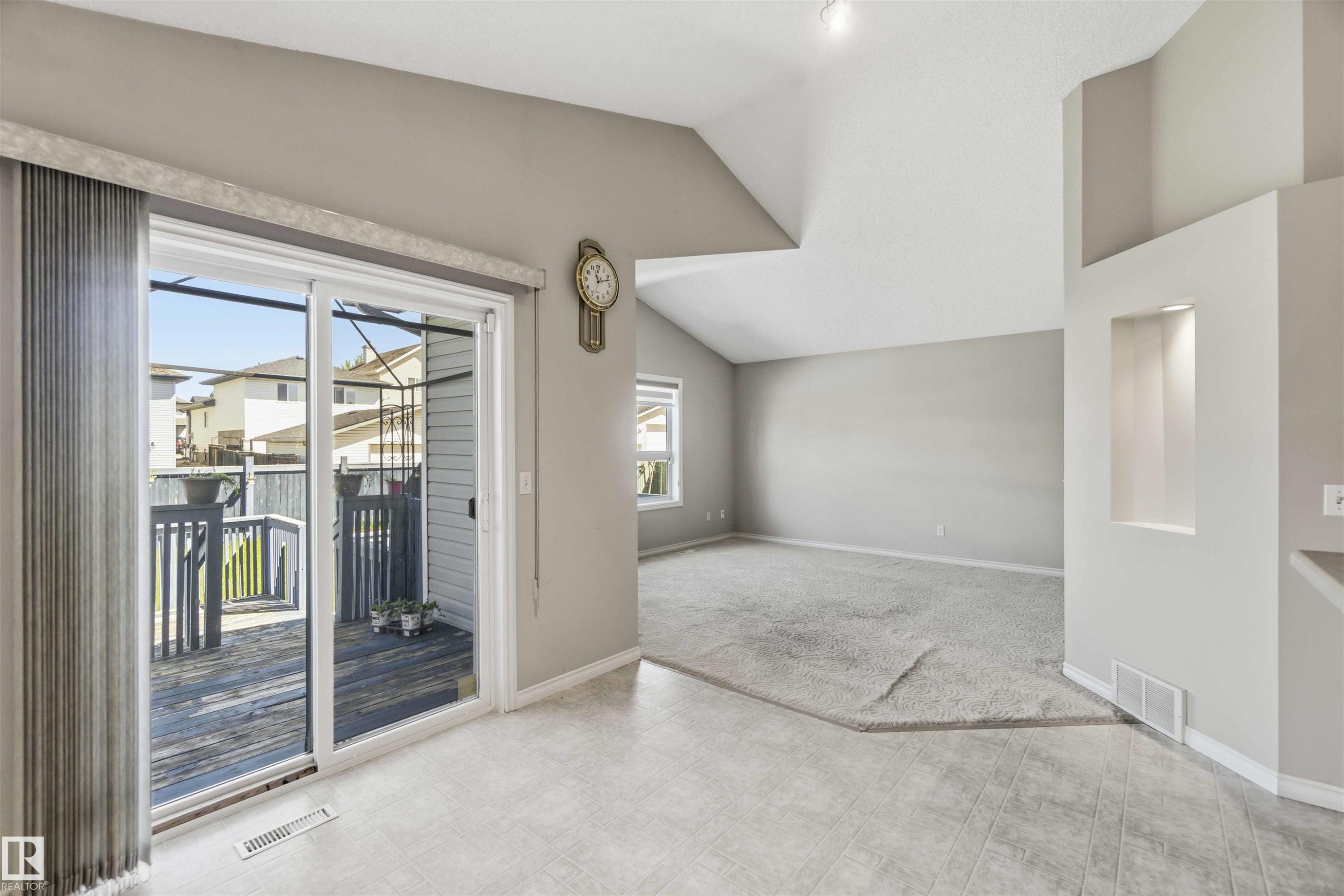 Sliding glass door opening to an outdoor deck - 2012 35A Avenue, Edmonton, AB