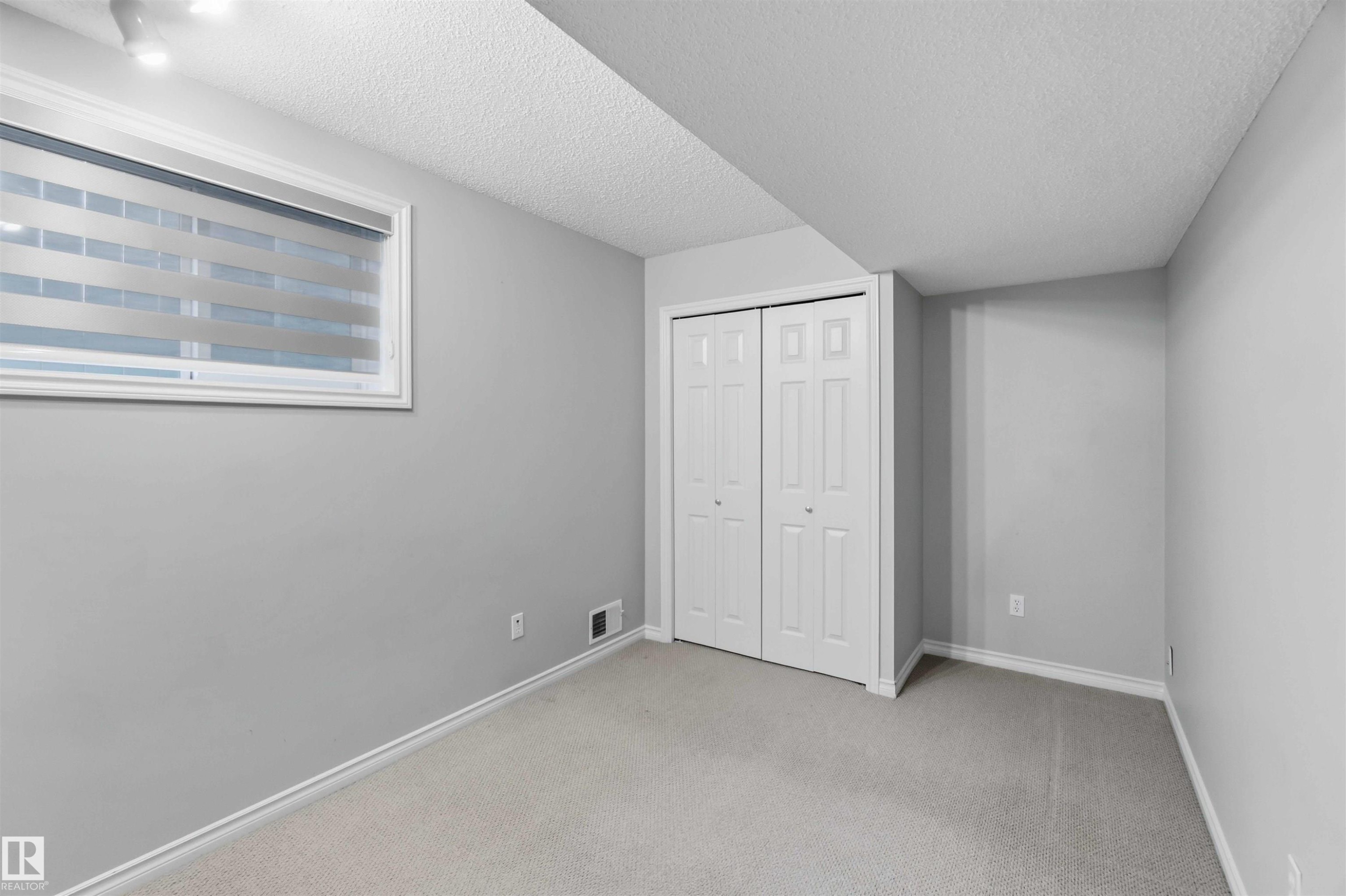 Carpeted room with light gray walls and white trim - 2012 35A Avenue, Edmonton, AB