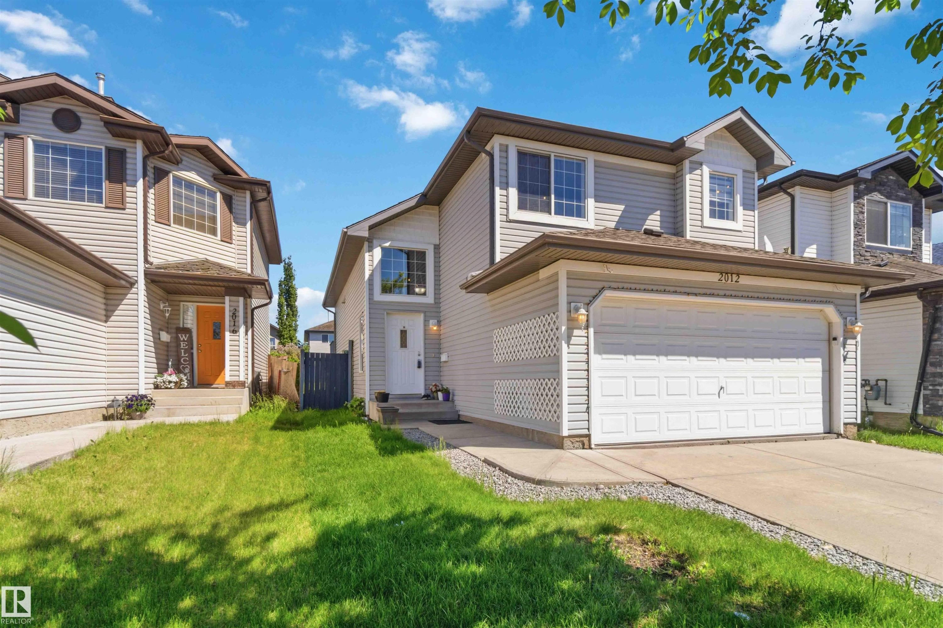 Two-story residence featuring light-colored siding and a contrasting brown roof - 2012 35A Avenue, Edmonton, AB