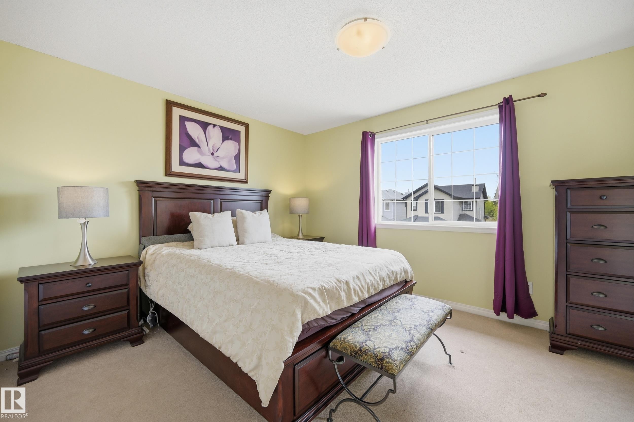 Carpeted room featuring a large window, a ceiling-mounted light fixture, and light-toned walls - 11628 167A Avenue, Edmonton, AB - Indoor Photo Showing Bedroom