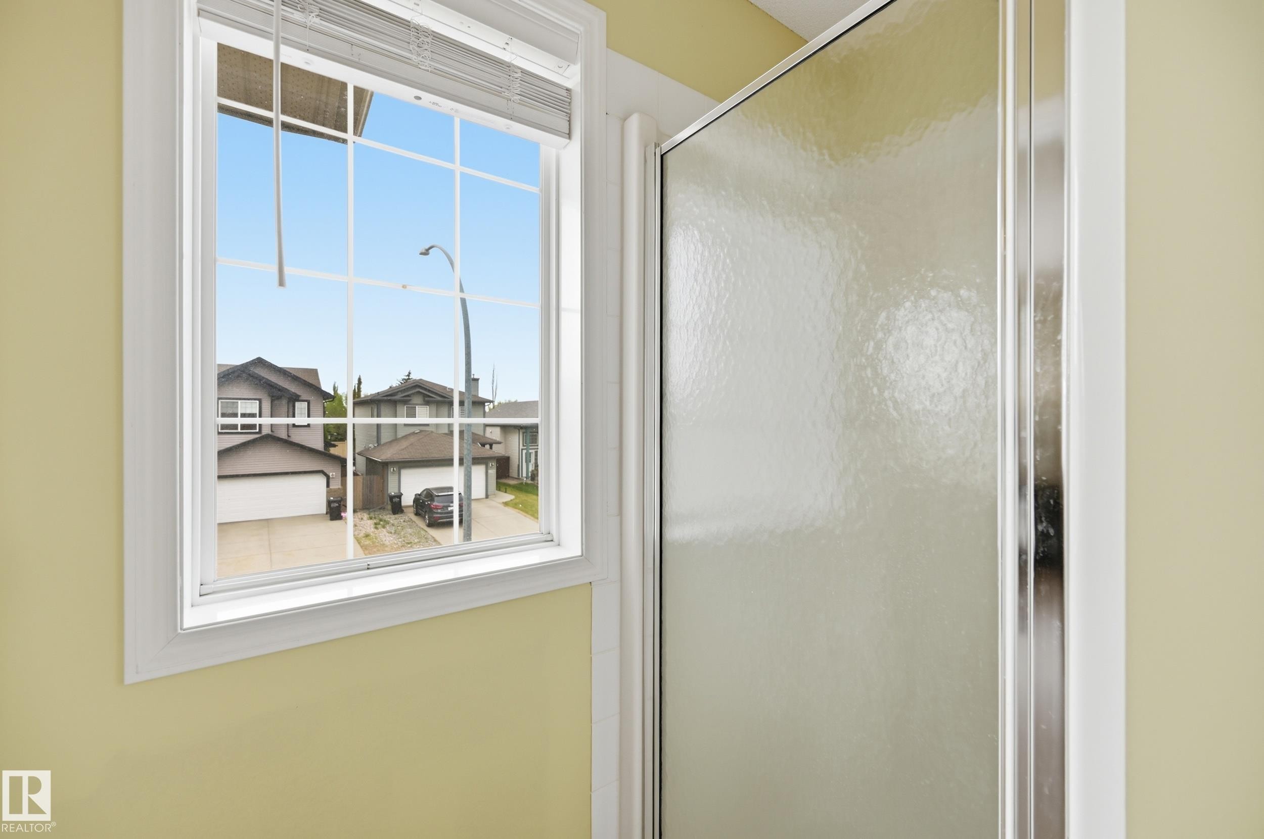 Window with white framing, integrated blinds, and grid-patterned panes - 11628 167A Avenue, Edmonton, AB - Indoor