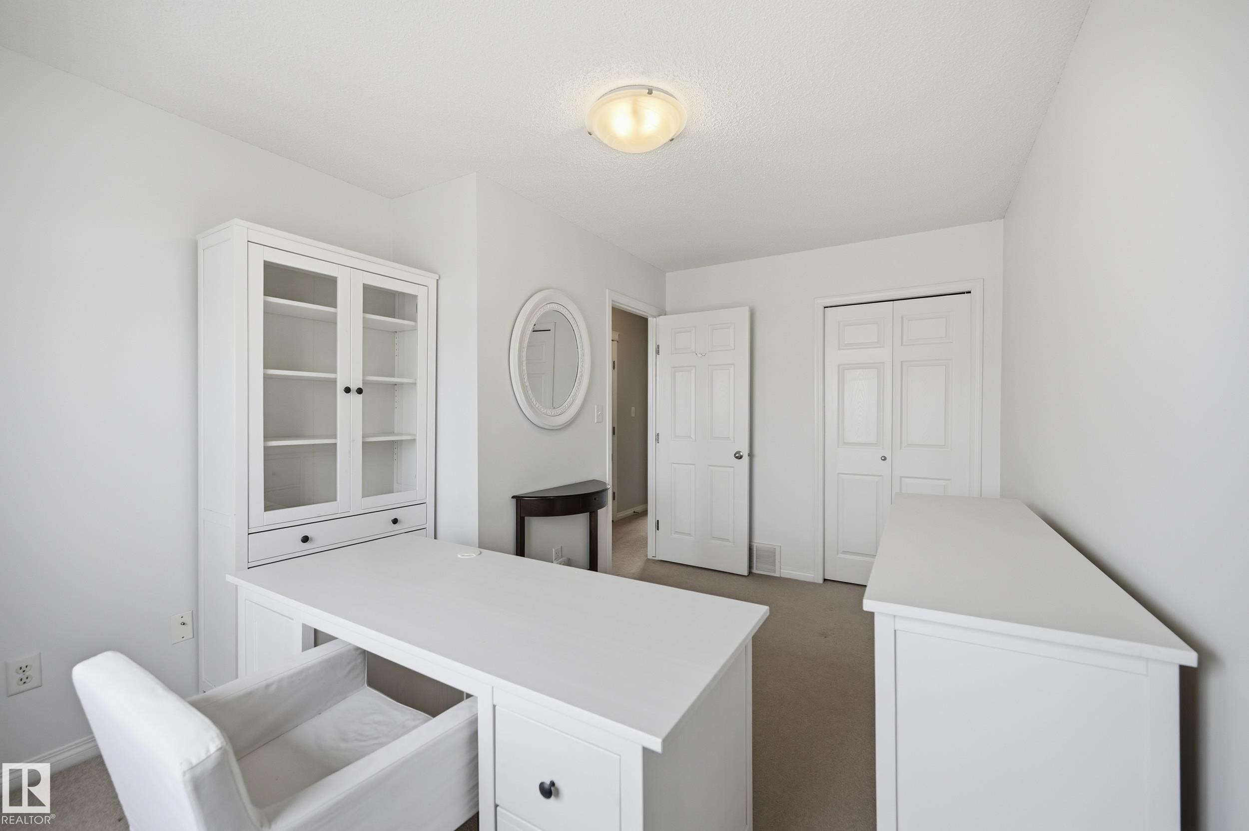 Neutral wall paint with carpet flooring, flush mount lighting, and a white interior door - 11628 167A Avenue, Edmonton, AB - Indoor Photo Showing Other Room