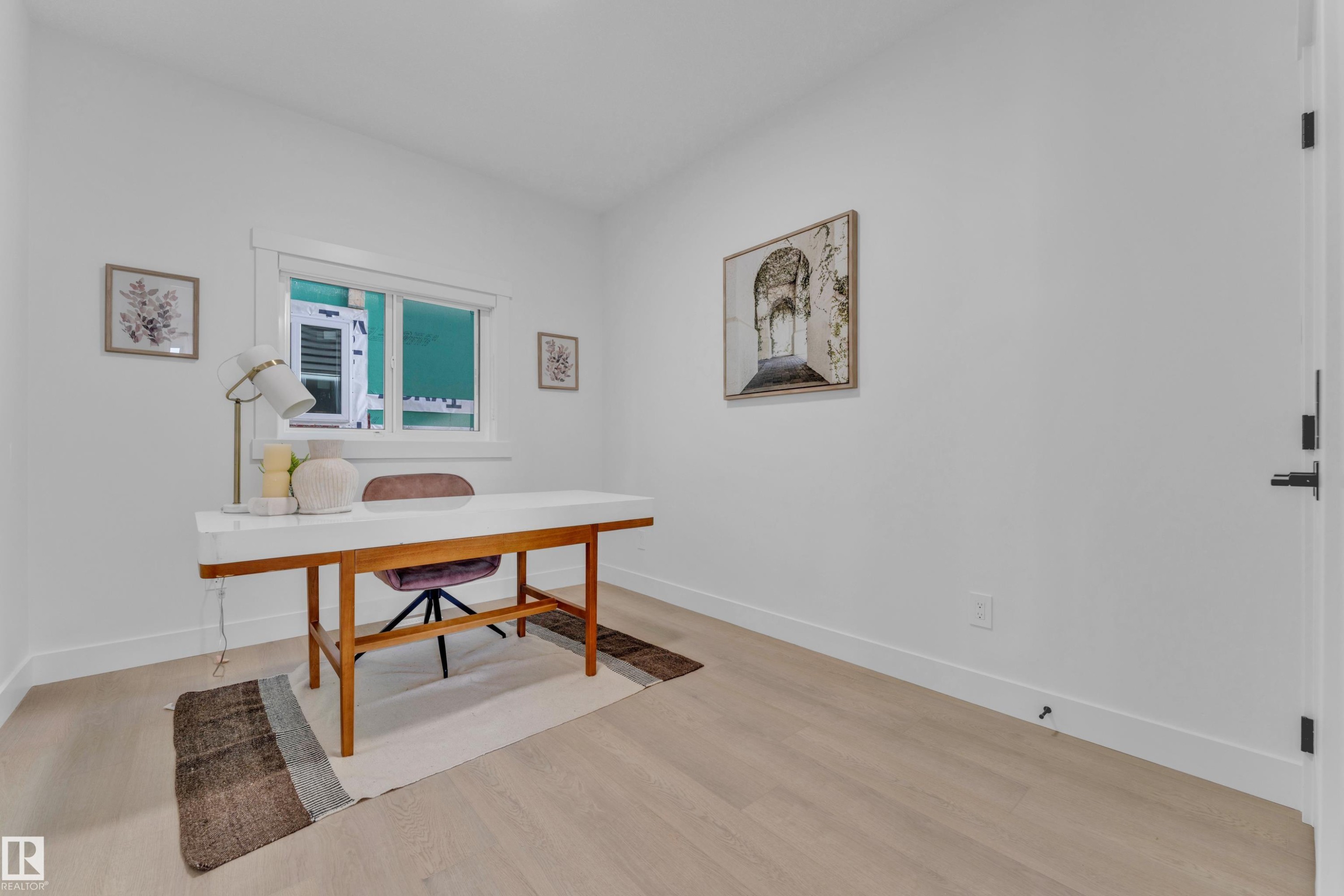Room featuring light wood-finish flooring, white walls, and a window with white trim - 206 Linden Loop, Leduc, AB