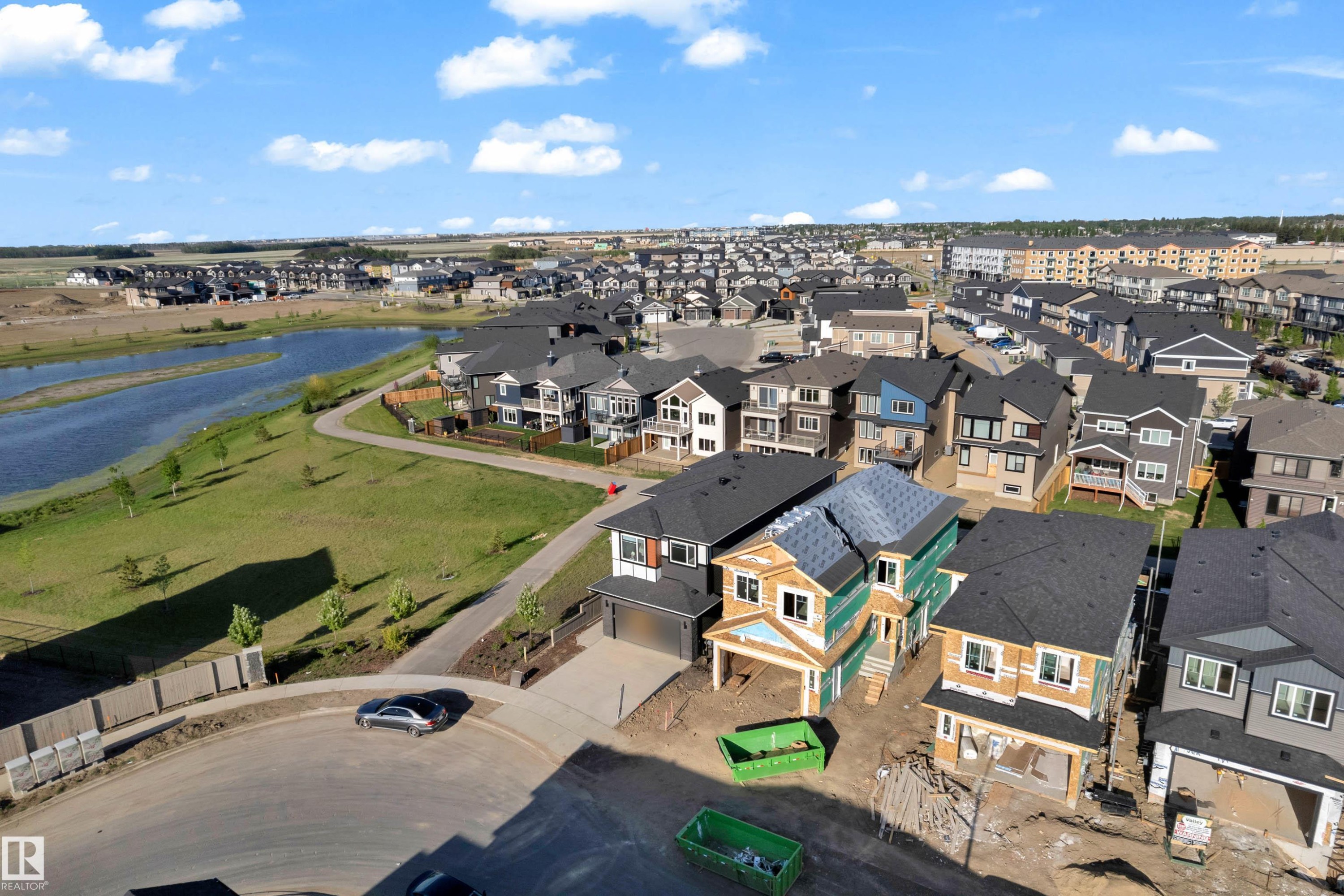Residential development featuring a natural water body, paved walking paths, and a variety of modern architectural styles - 206 Linden Loop, Leduc, AB