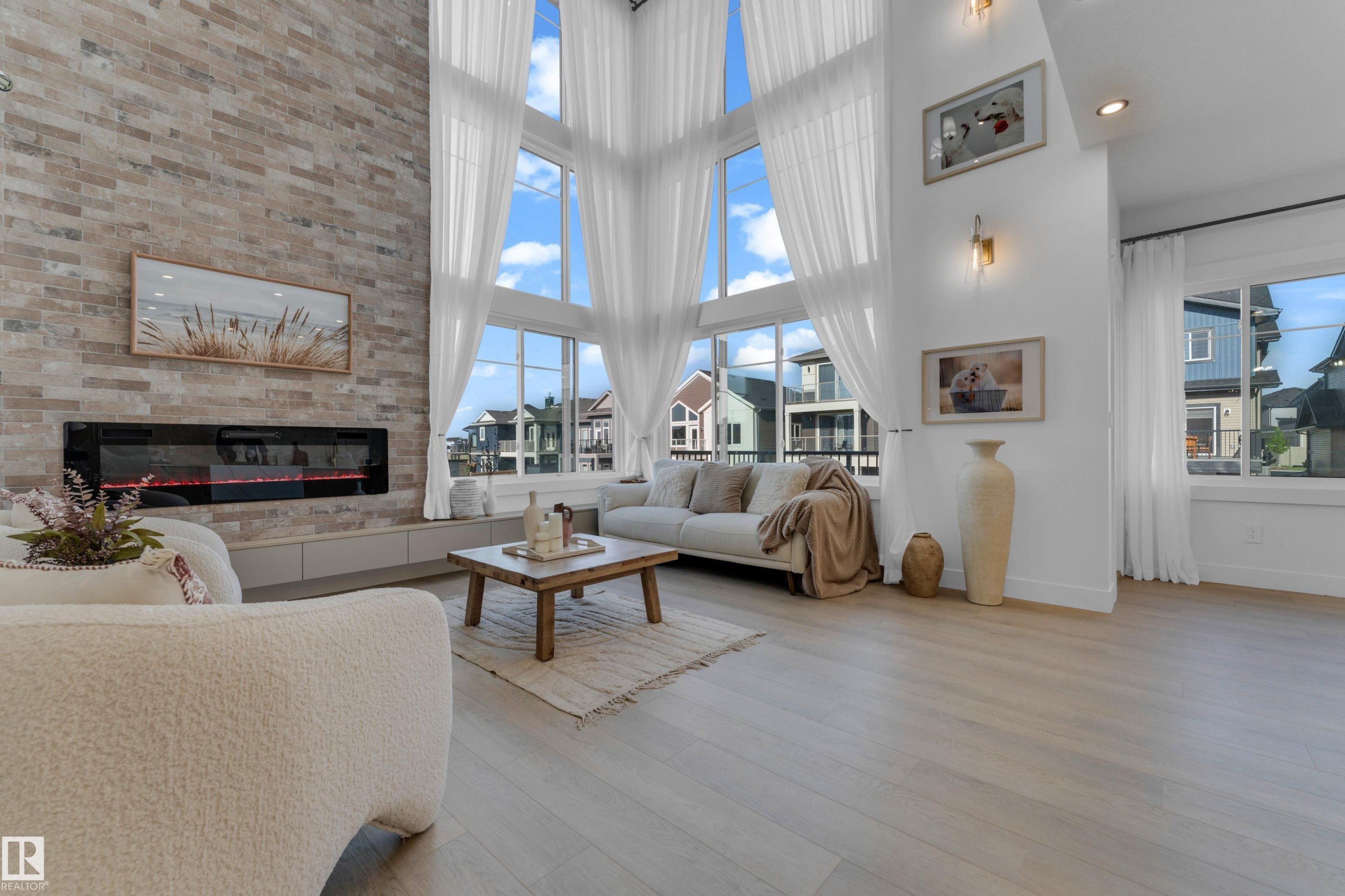 Vaulted ceilings with expansive windows and sheer drapery - 206 Linden Loop, Leduc, AB