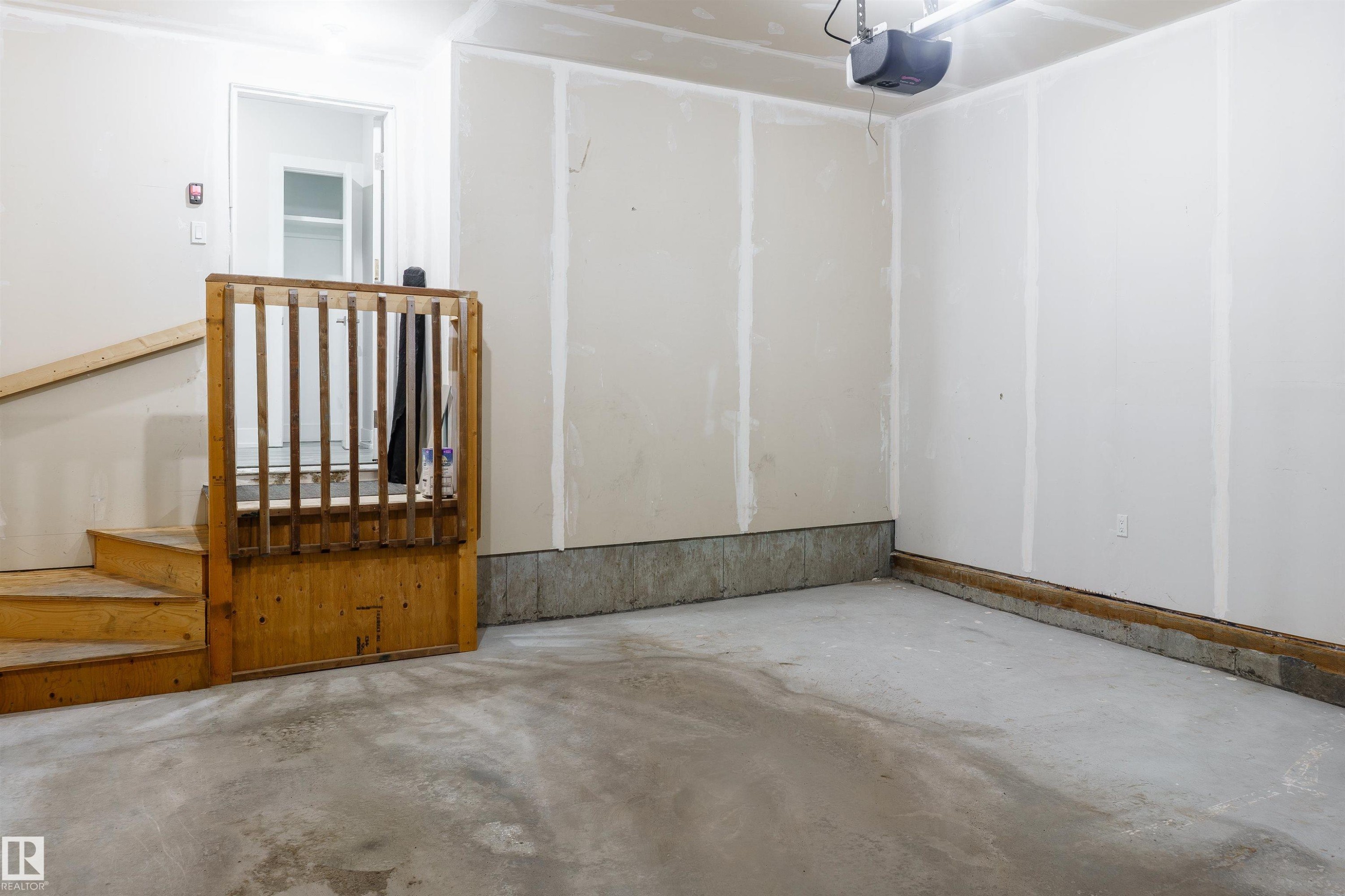 Spacious garage with concrete flooring and unfinished drywall walls - 2104 160 Street Sw, Edmonton, AB - Indoor