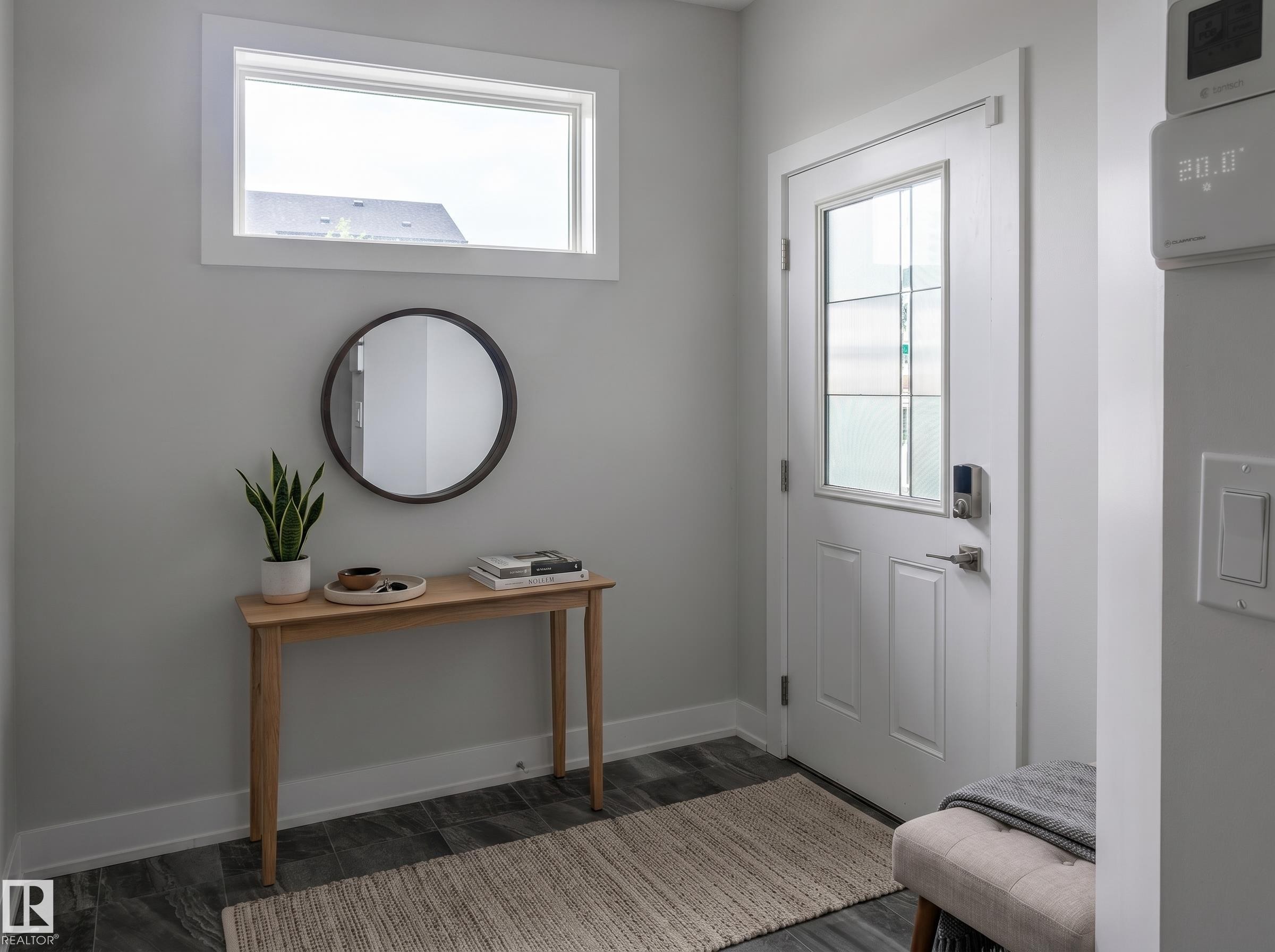 Entryway featuring a white paneled door with decorative glass inserts, a smart lock system, and dark wood-finish flooring - 2104 160 Street Sw, Edmonton, AB - Indoor Photo Showing Other Room