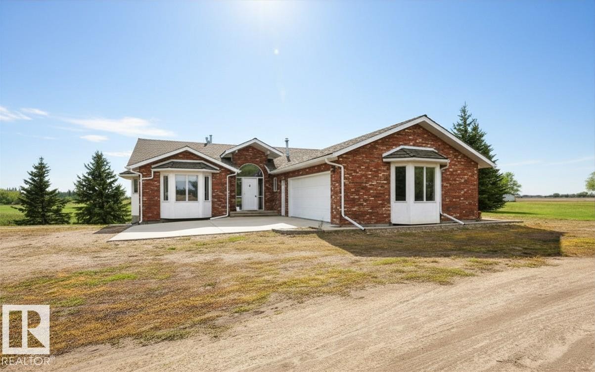 Red brick exterior with white trim and bay windows - 60230 Rg Rd 271, Rural Westlock County, AB