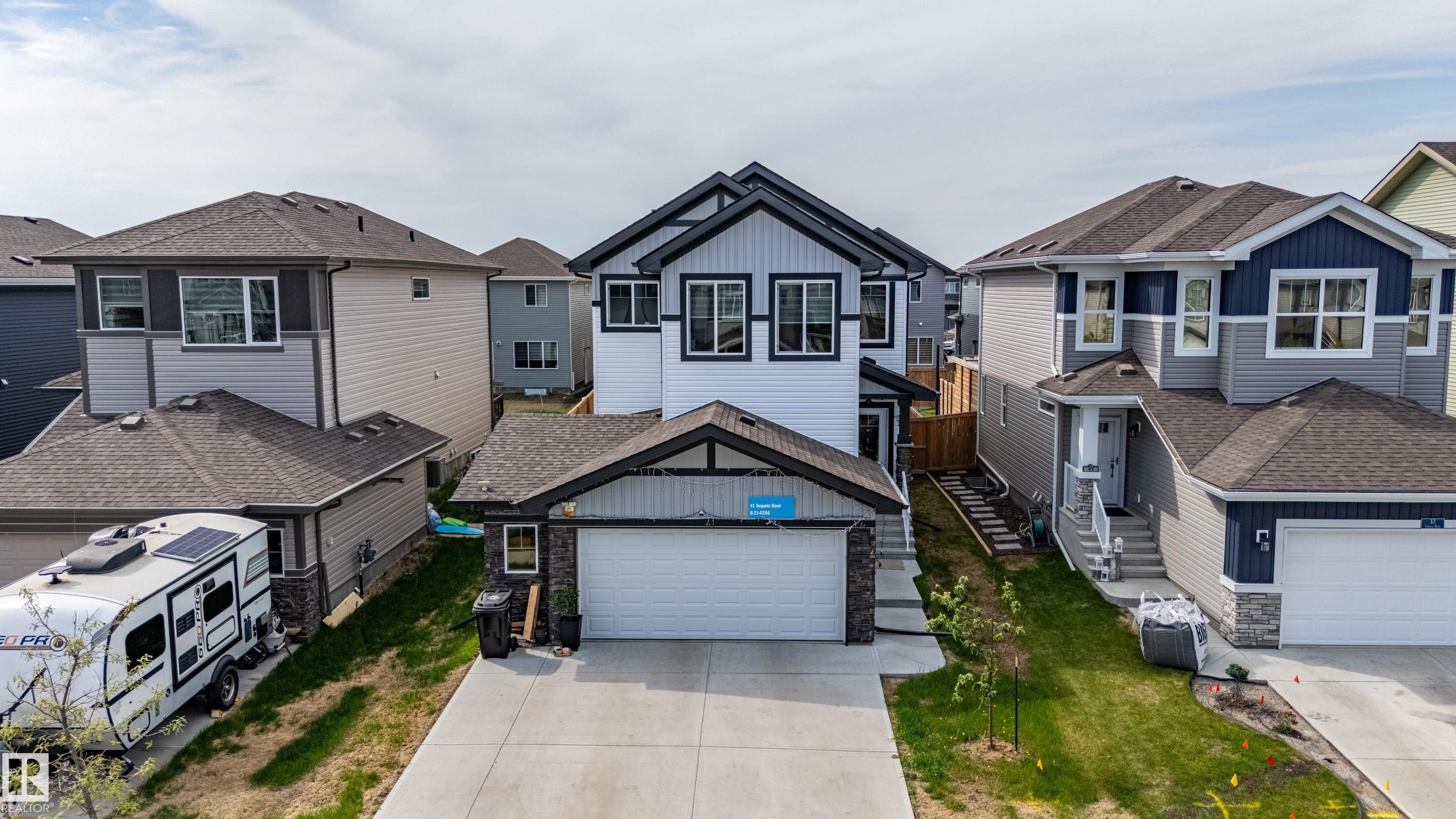 Contemporary two-story residence featuring a white and black exterior with vertical and horizontal siding - 41 Sequoia Bend, Fort Saskatchewan, AB